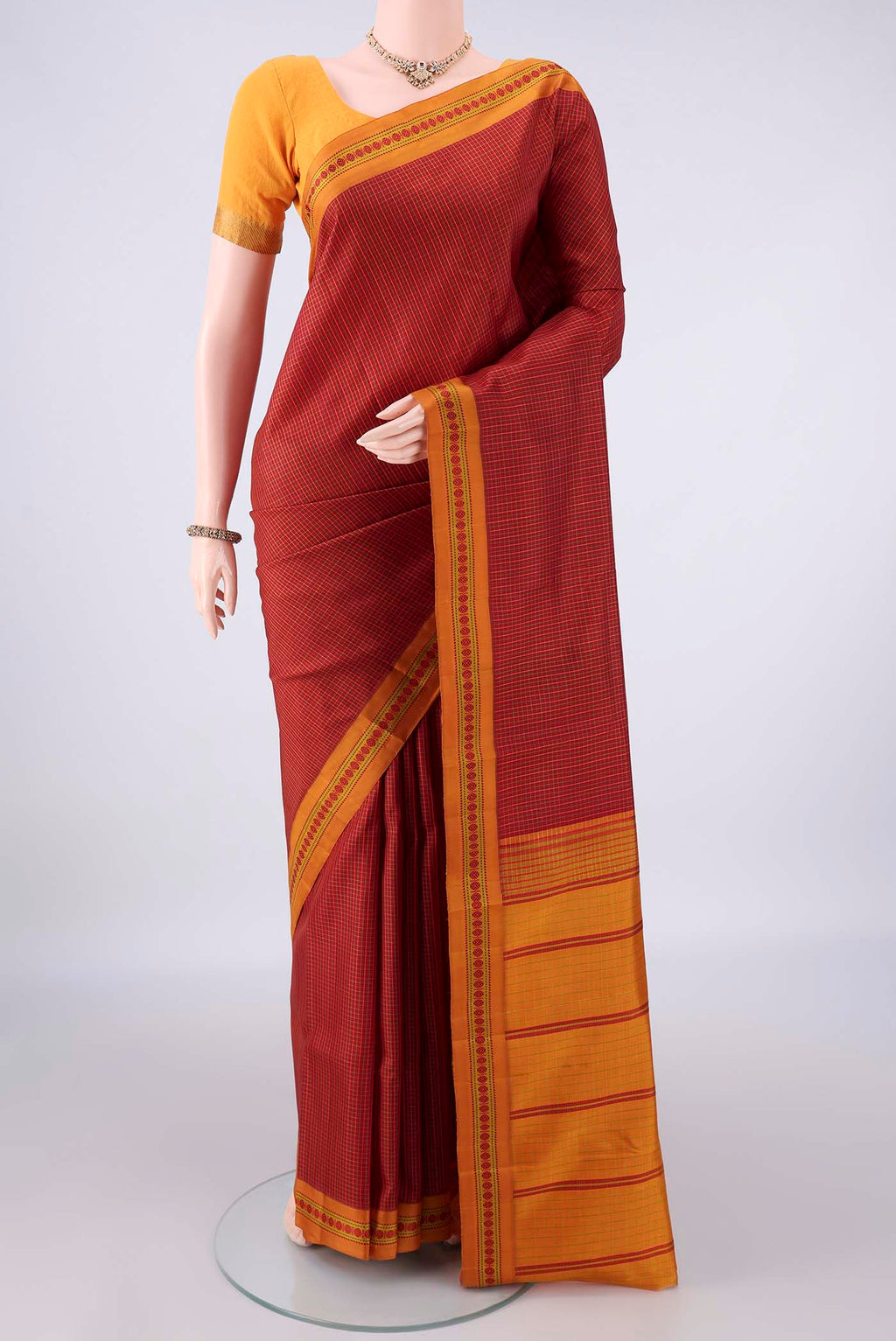 Pure Silk Red Dual Tone Kanjivaram Saree with Checked design on the body and Thread Border.  displayed on a mannequin