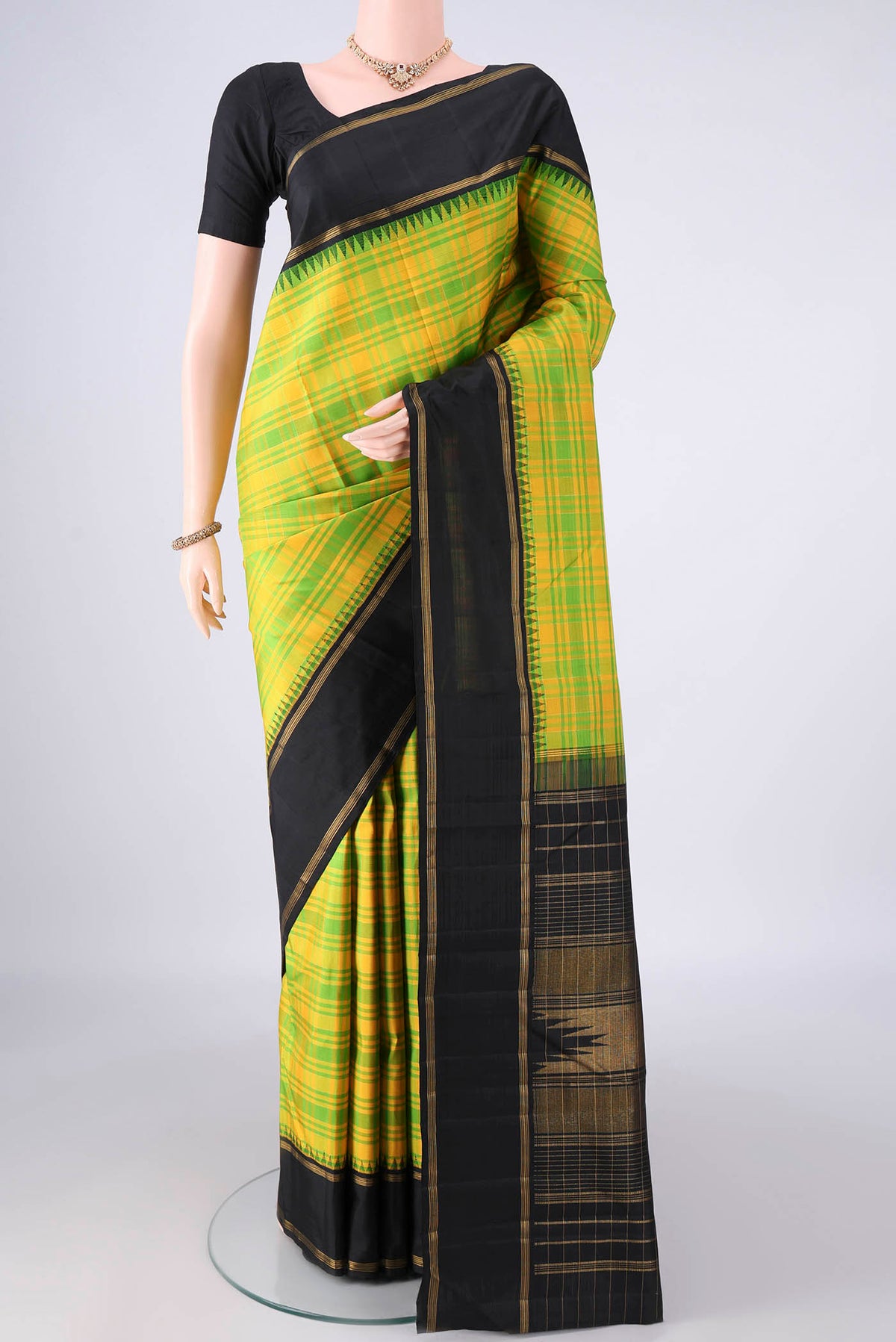 Pure Silk Parrot Green Kanjivaram Saree with Checked design on the body and Zari Border.  displayed on a mannequin