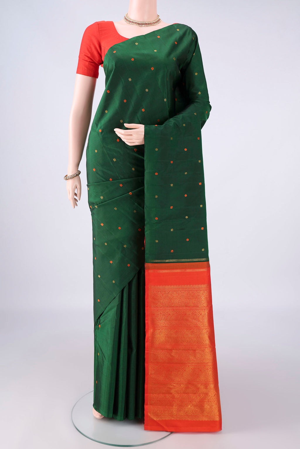 Pure Silk Green Kanjivaram Saree with Thread Butta on the body and Without Border.  displayed on a mannequin