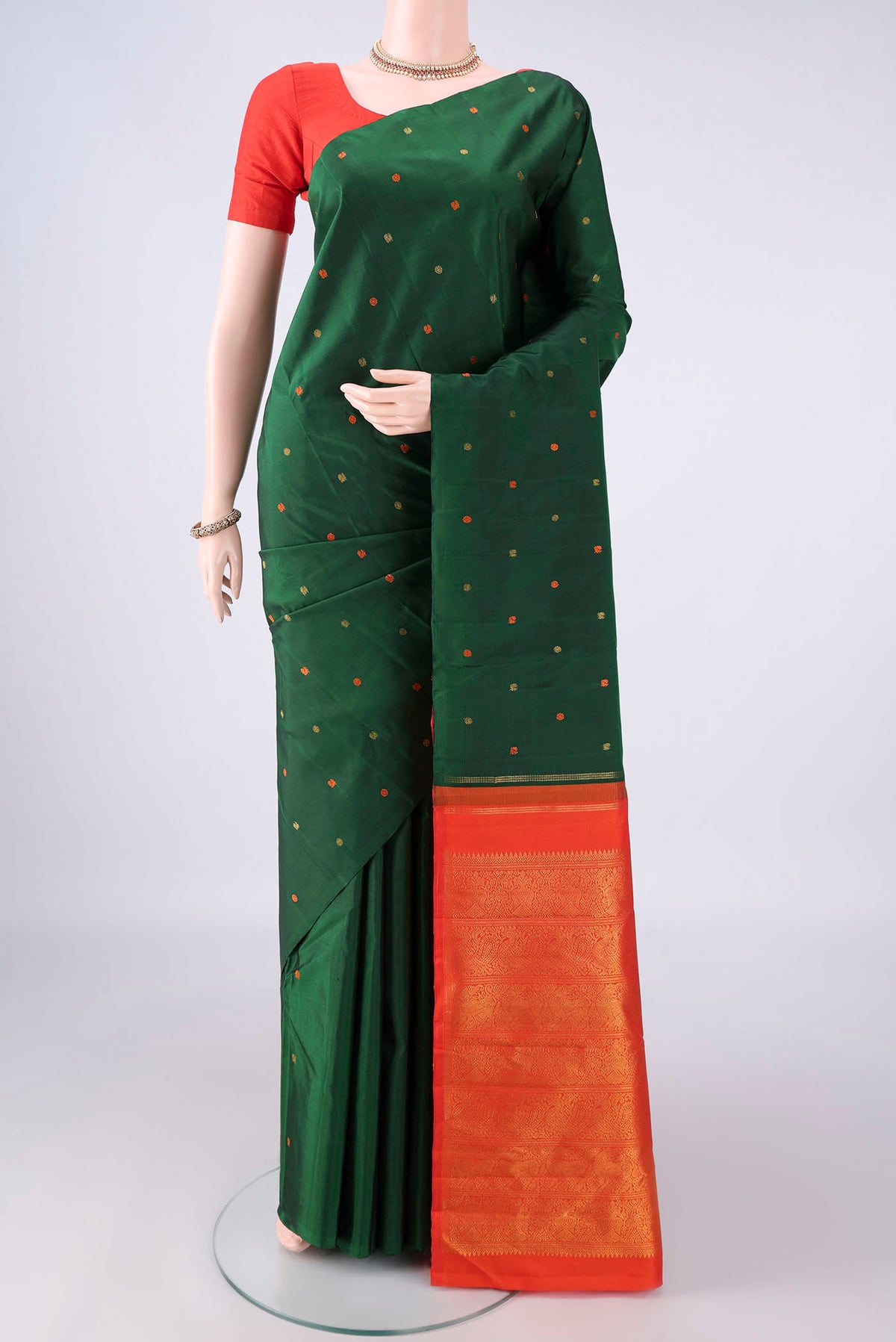 Pure Silk Green Kanjivaram Saree with Thread Butta on the body and Without Border.  displayed on a mannequin