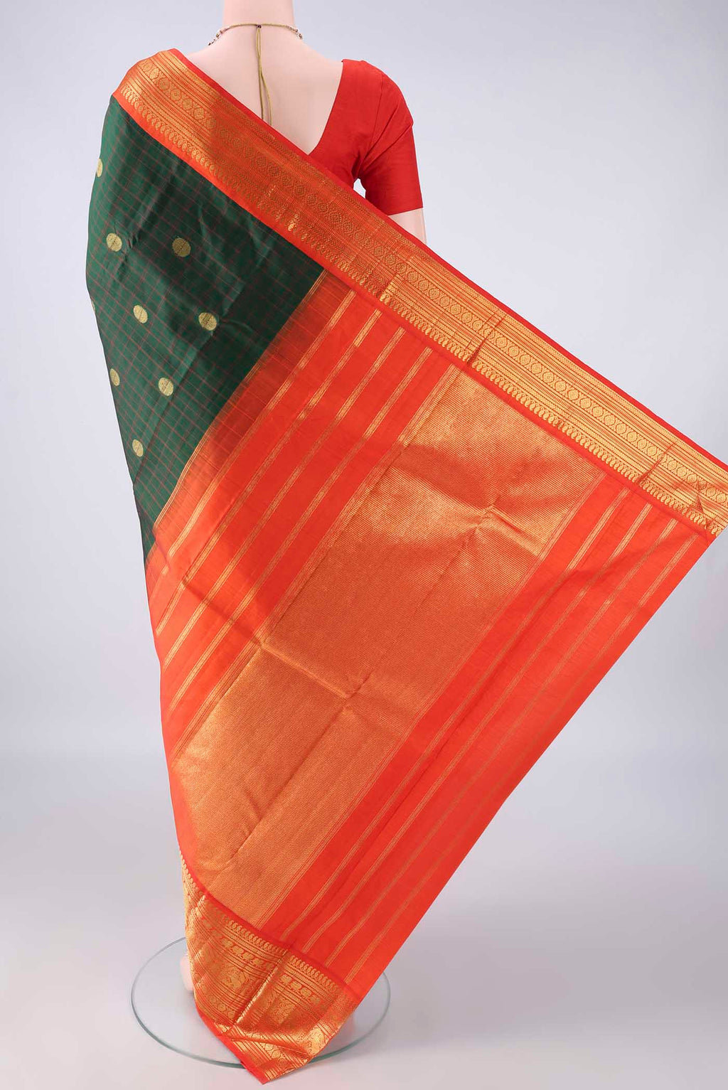 Flat view of Pure Silk Bottle Green Kanchipuram Saree with Checked design on the body and Zari Border. 