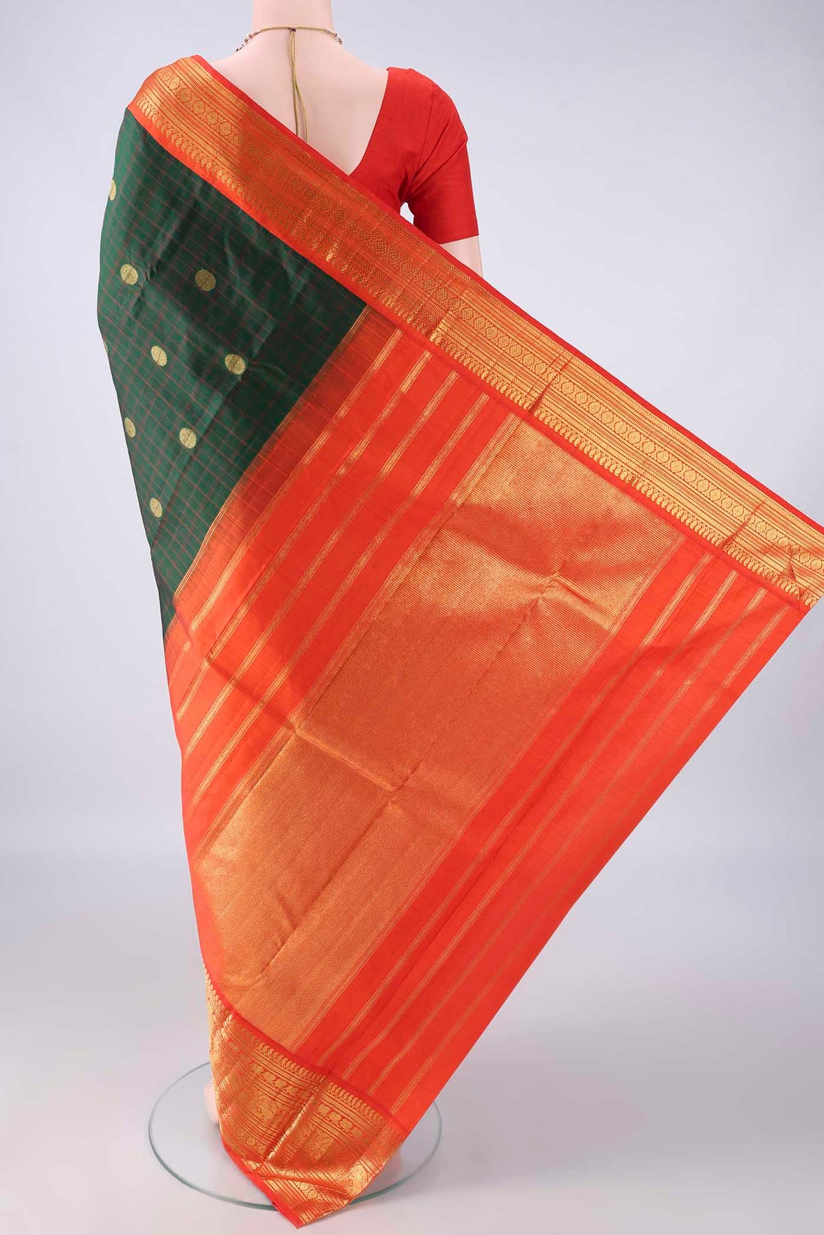 Flat view of Pure Silk Bottle Green Kanchipuram Saree with Checked design on the body and Zari Border. 