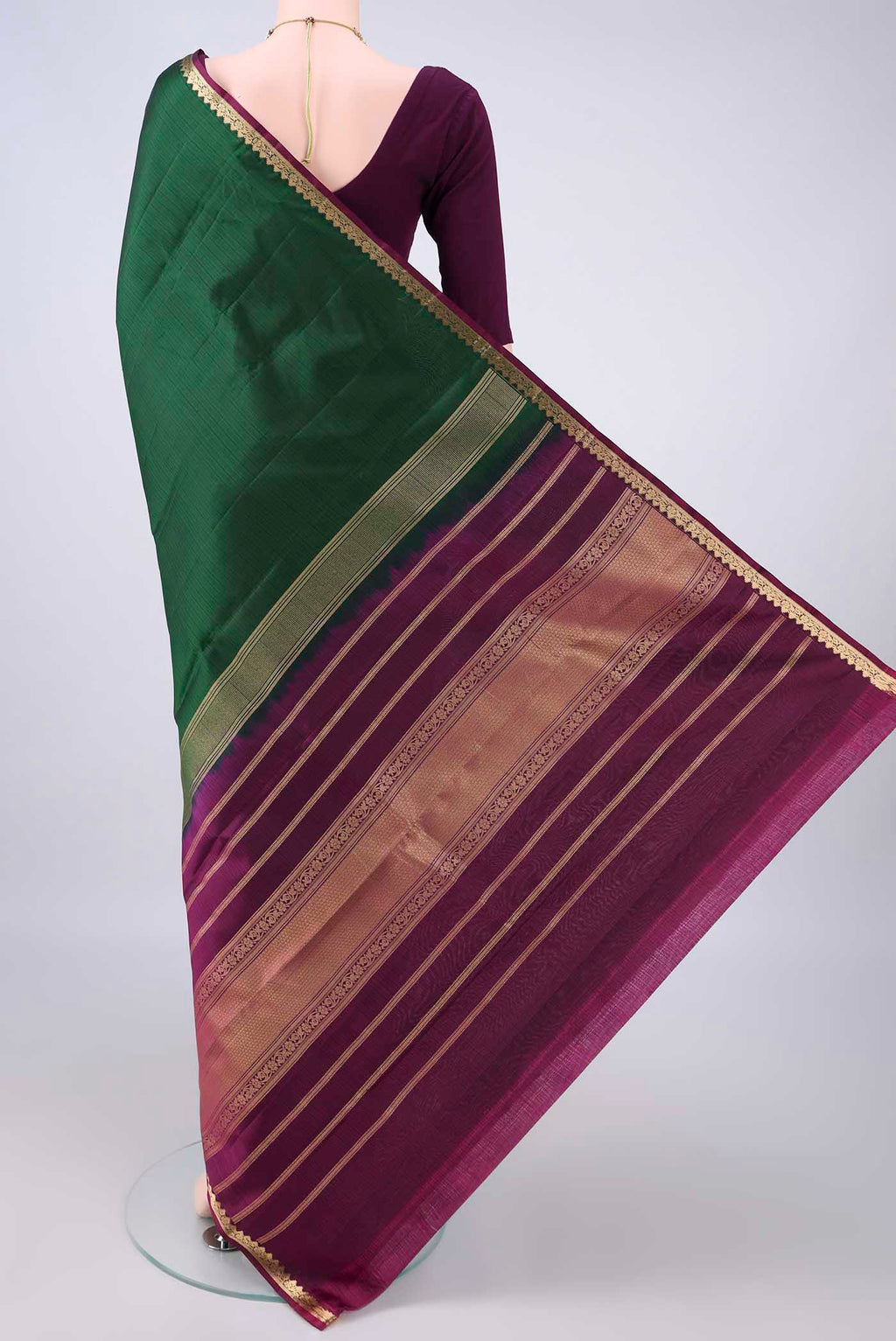 Flat view of Pure Silk Bottle Green Kanjivaram Saree with Plain Body and Zari Border. 