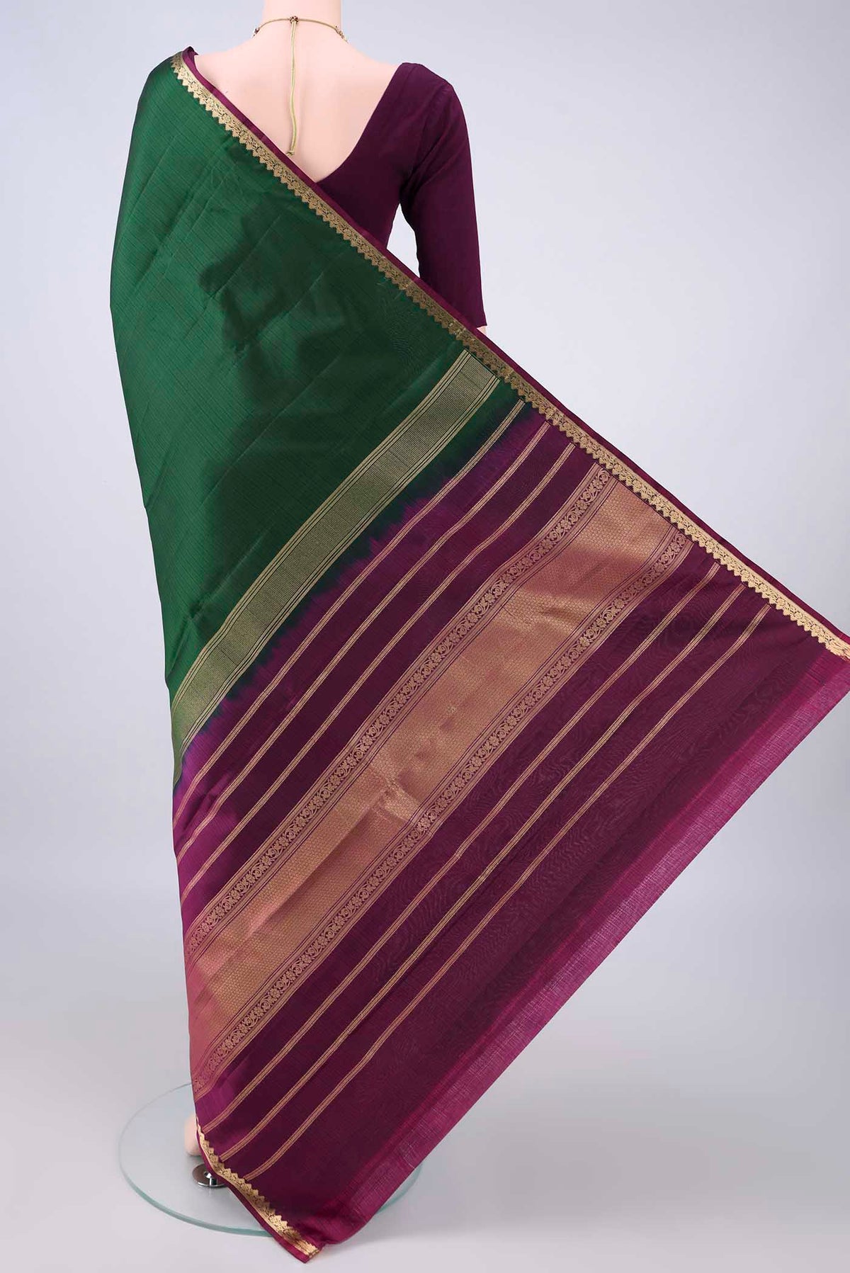 Flat view of Pure Silk Bottle Green Kanjivaram Saree with Plain Body and Zari Border. 