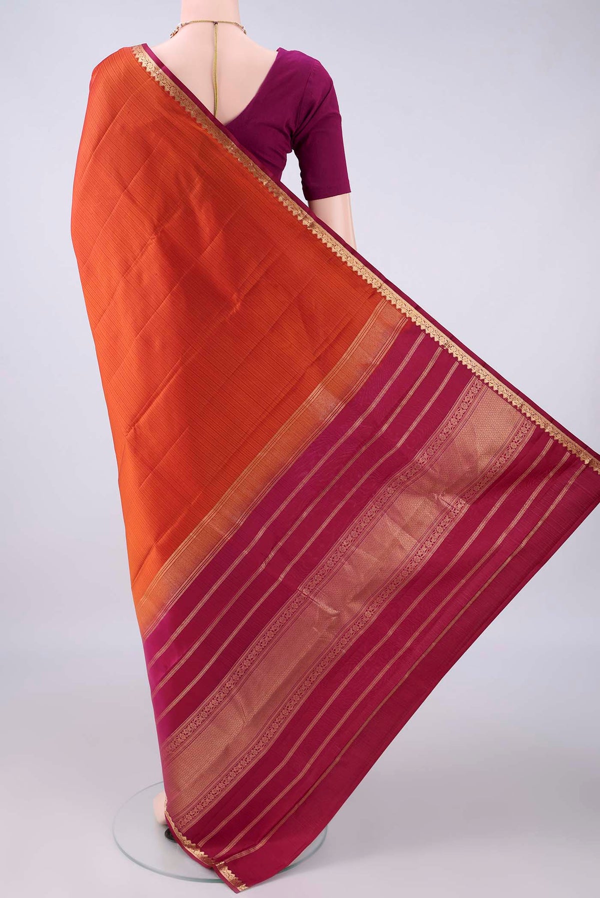Flat view of Pure Silk Orange Kanjivaram Saree with Plain Body and Zari Border. 