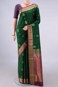 Pure Silk Bottle Green Soft Saree with Zari Butta on the body and Zari Border.  displayed on a mannequin