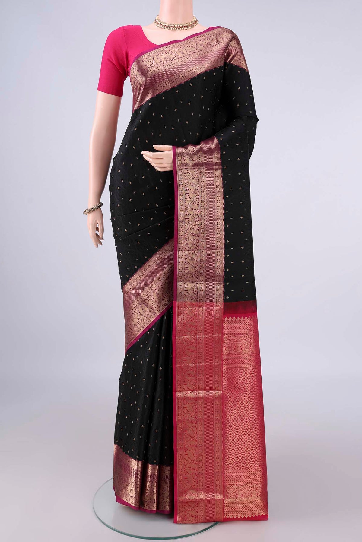 Pure Silk Black Soft Saree with Jacquard With Zari Butta on the body and Zari Border.  displayed on a mannequin
