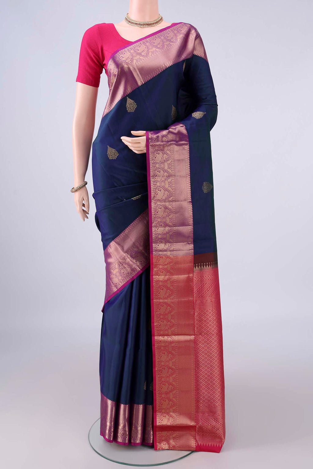 Pure Silk Peacock Blue Dual Tone Soft Saree with Zari Butta on the body and Zari Border.  displayed on a mannequin