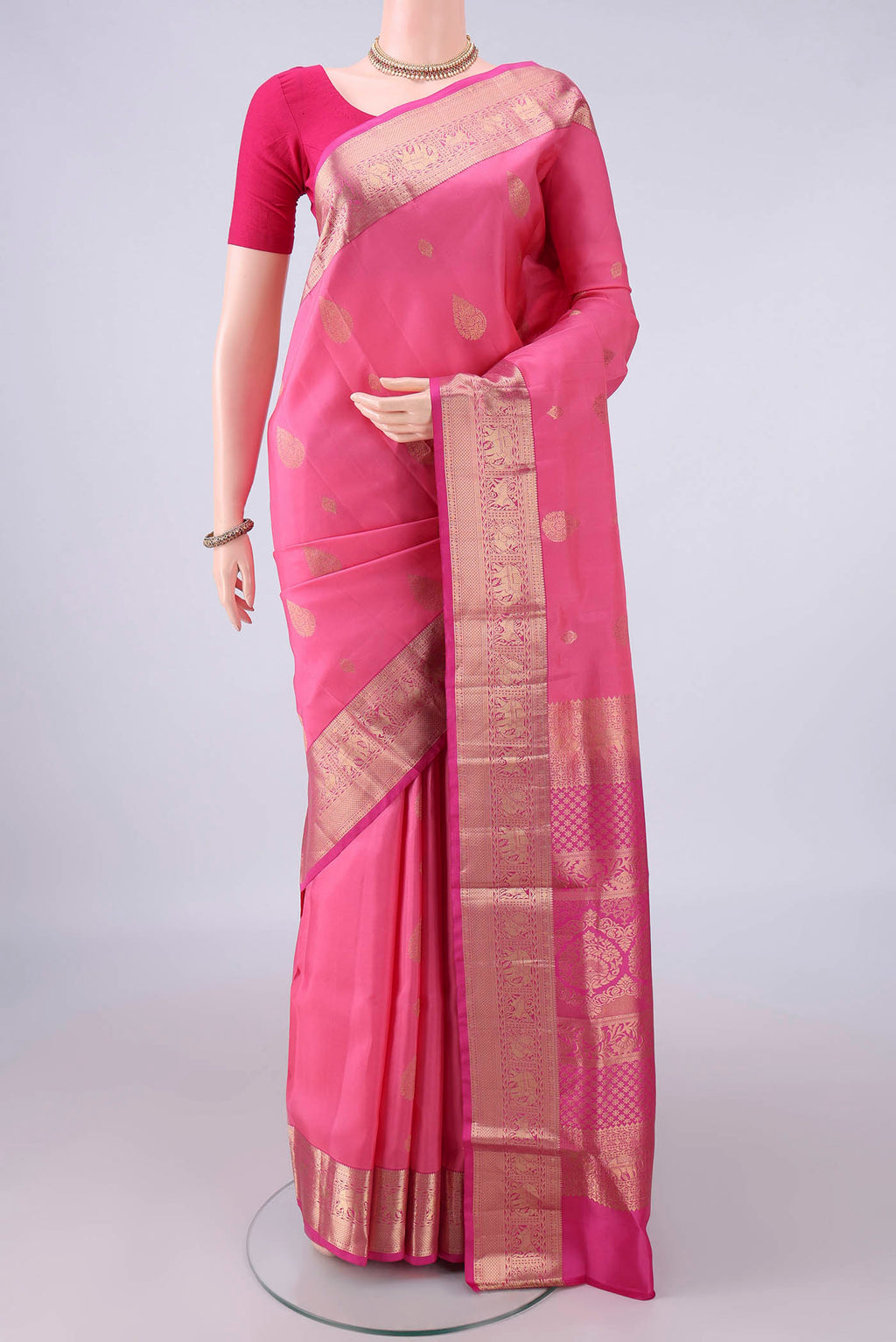 Pure Silk Pink Soft Saree with Zari Butta on the body and Zari Border.  displayed on a mannequin