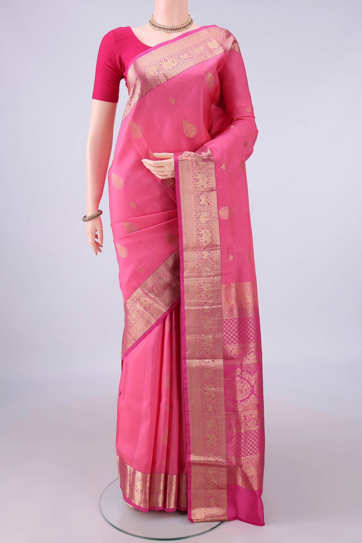 Pure Silk Pink Soft Saree with Zari Butta on the body and Zari Border.  displayed on a mannequin