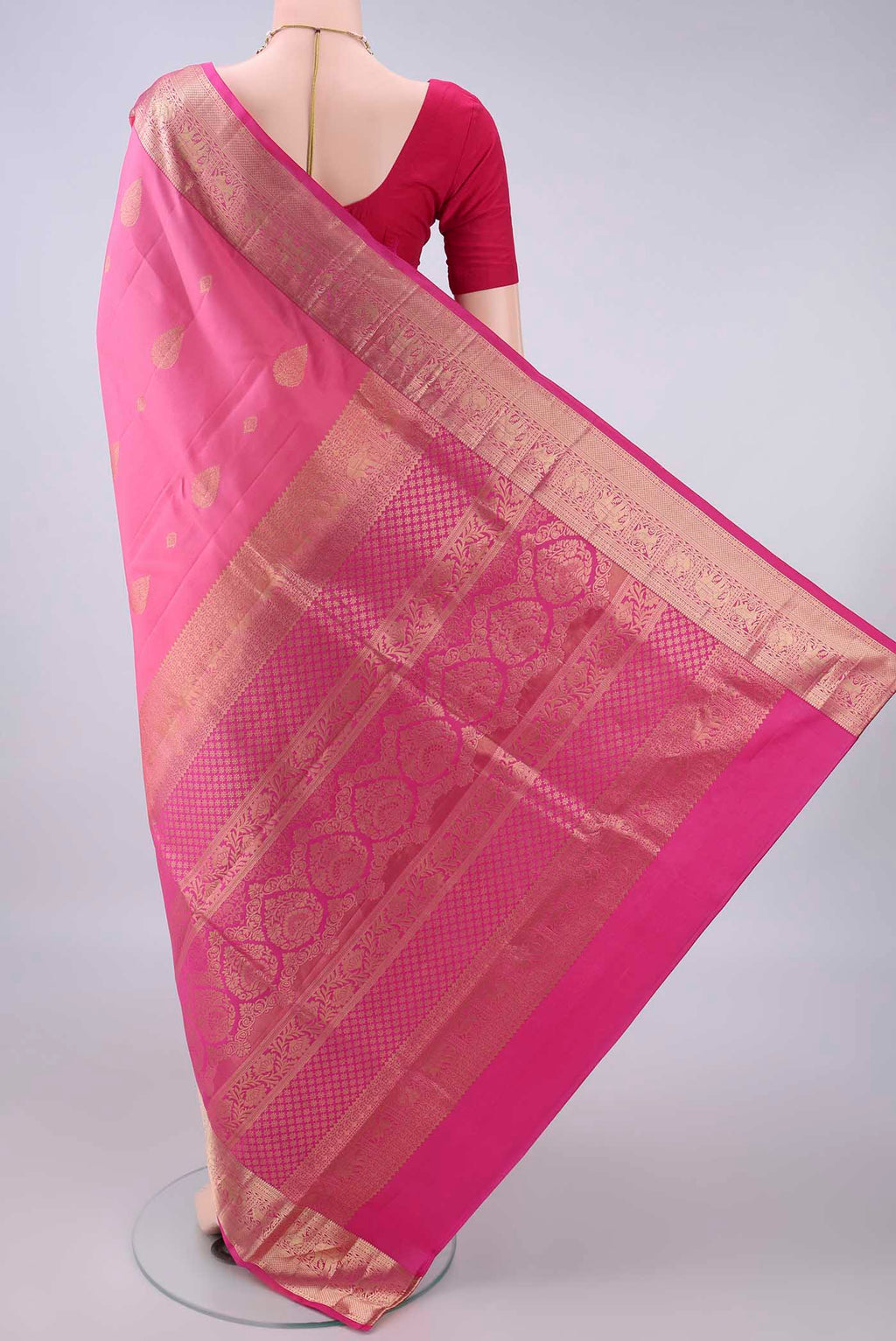 Flat view of Pure Silk Pink Soft Saree with Zari Butta on the body and Zari Border. 