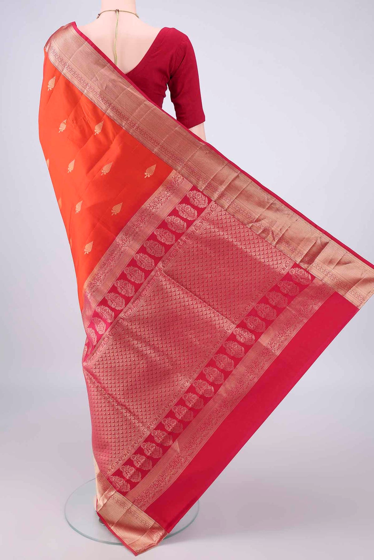 Flat view of Pure Silk Orange Soft Saree with Zari Butta on the body and Zari Border. 