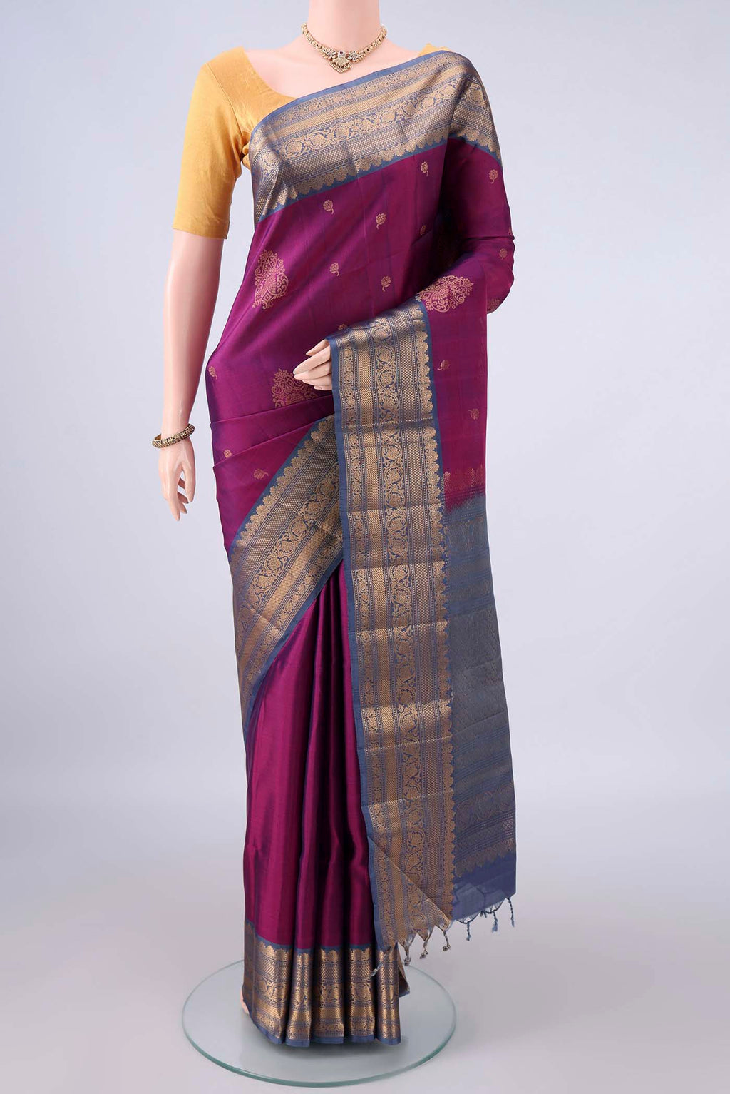 Pure Silk Magenta Soft Saree with Zari Butta on the body and Zari Border.  displayed on a mannequin