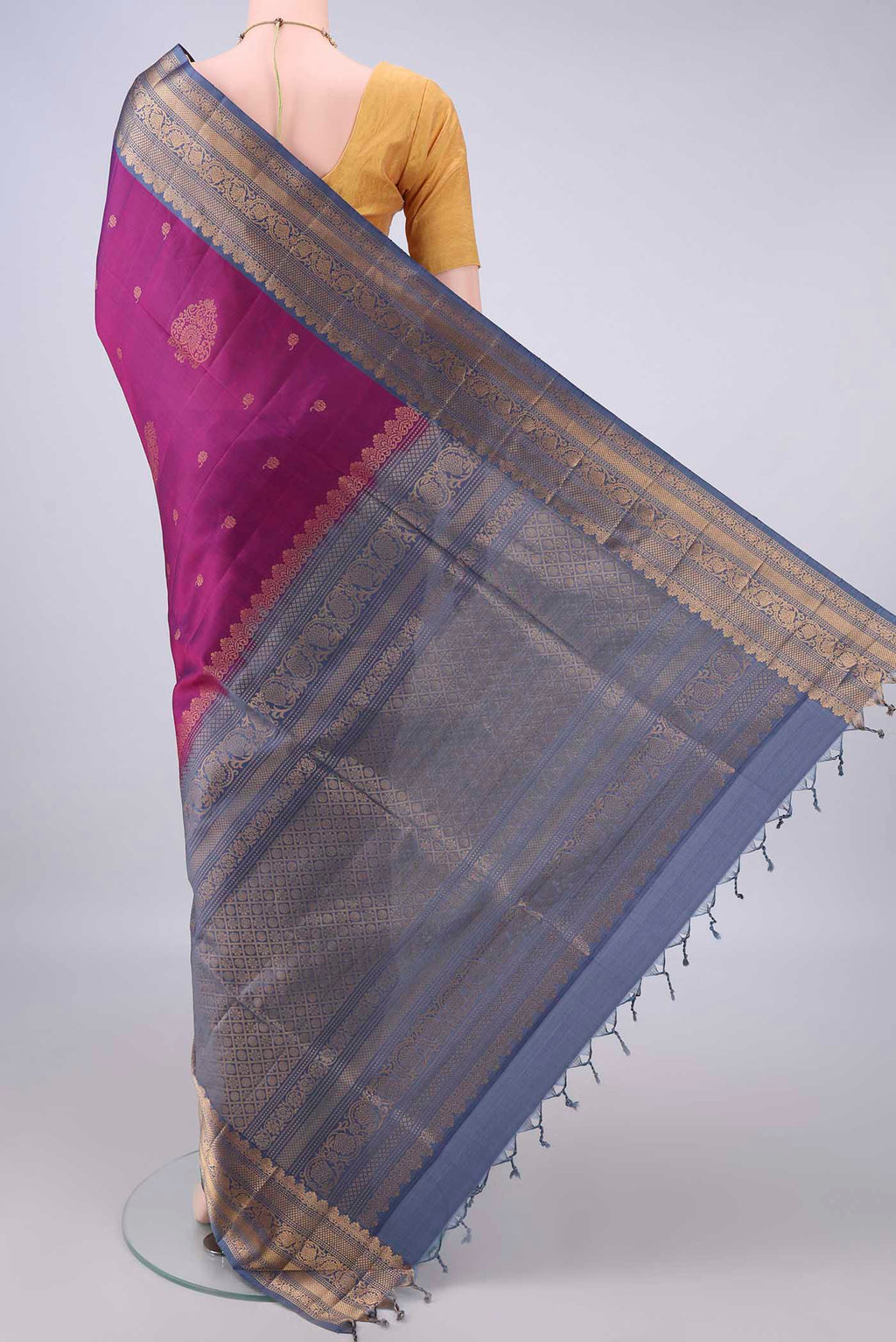 Flat view of Pure Silk Magenta Soft Saree with Zari Butta on the body and Zari Border. 