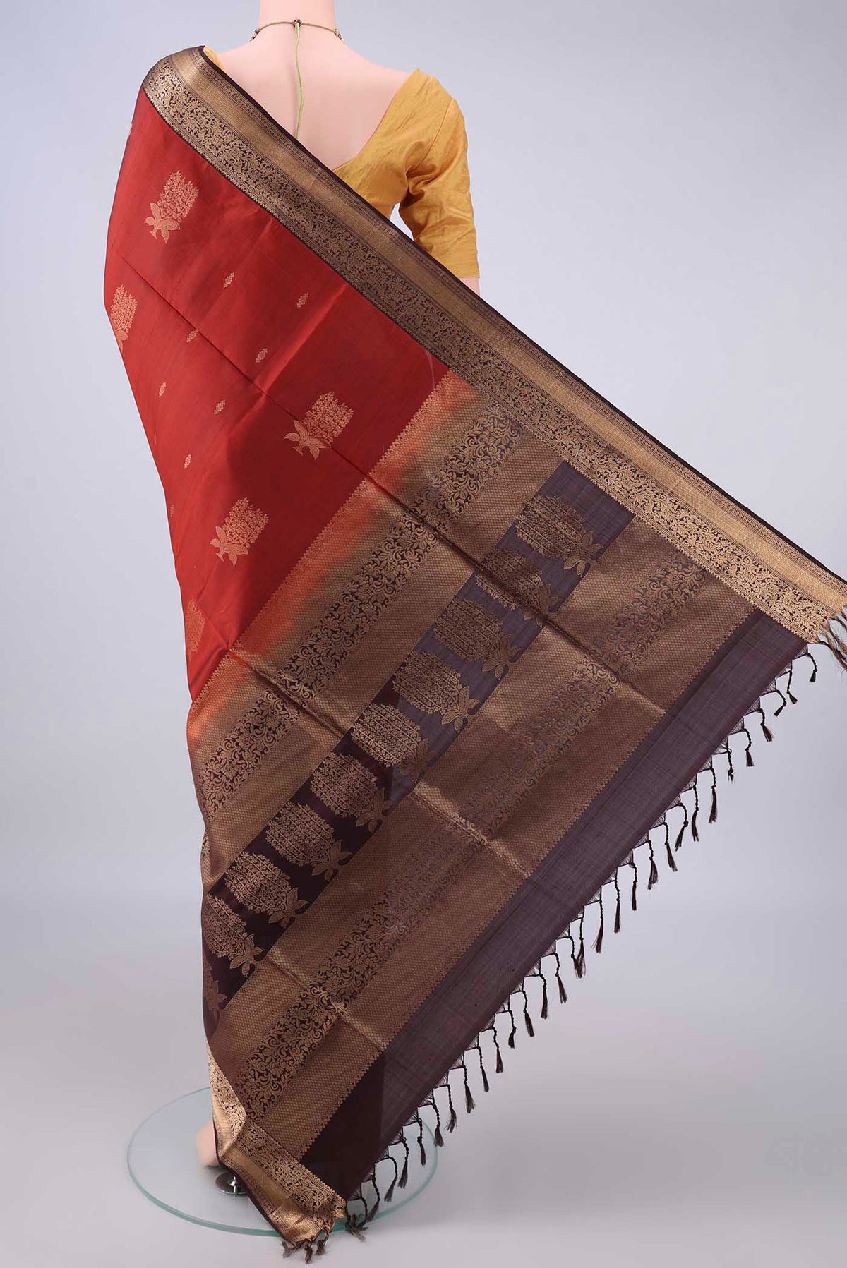 Flat view of Pure Silk Rust Soft Saree with Zari Butta on the body and Zari Border. 