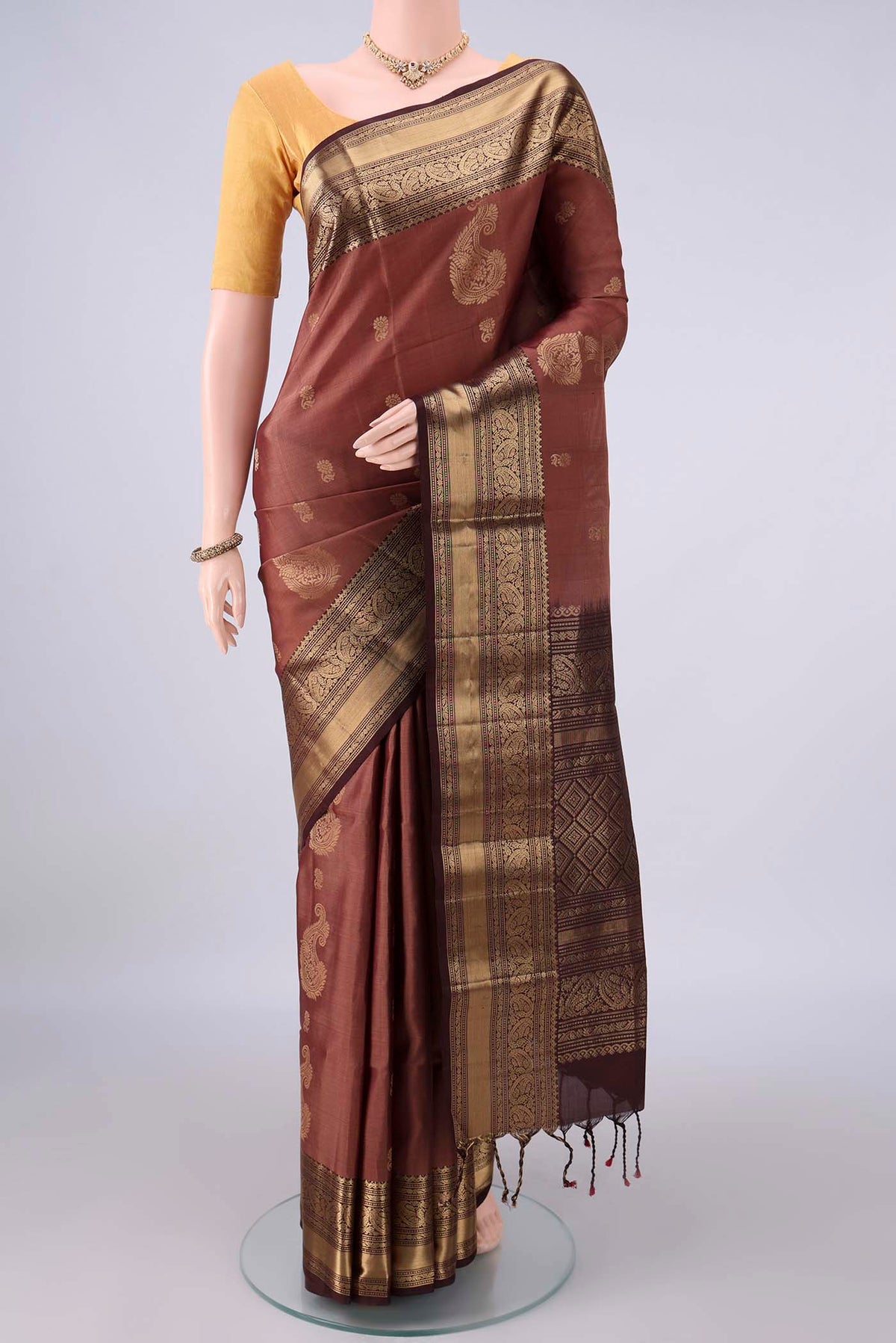 Pure Silk Brown Soft Saree with Zari Butta on the body and Zari Border.  displayed on a mannequin