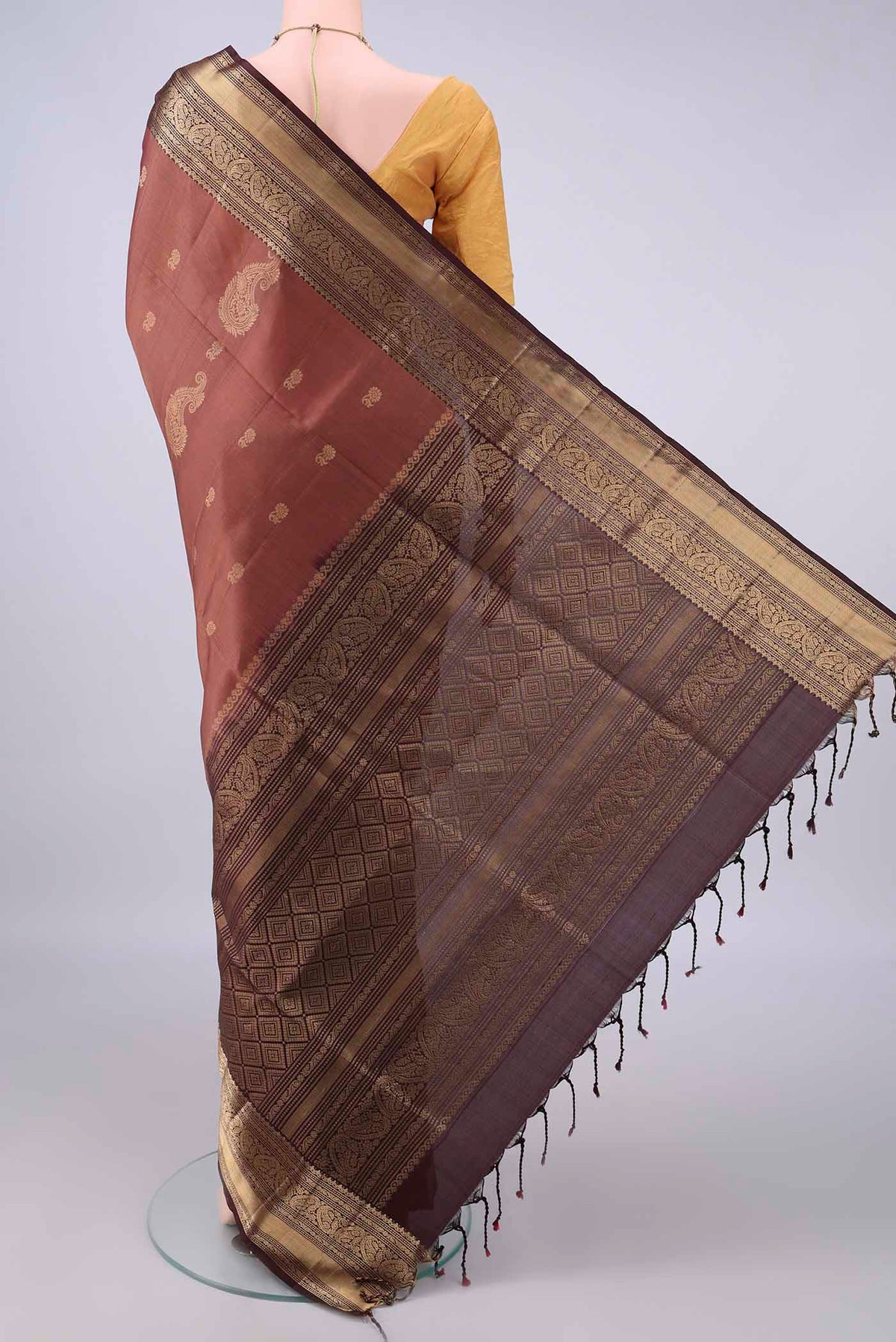 Flat view of Pure Silk Brown Soft Saree with Zari Butta on the body and Zari Border. 
