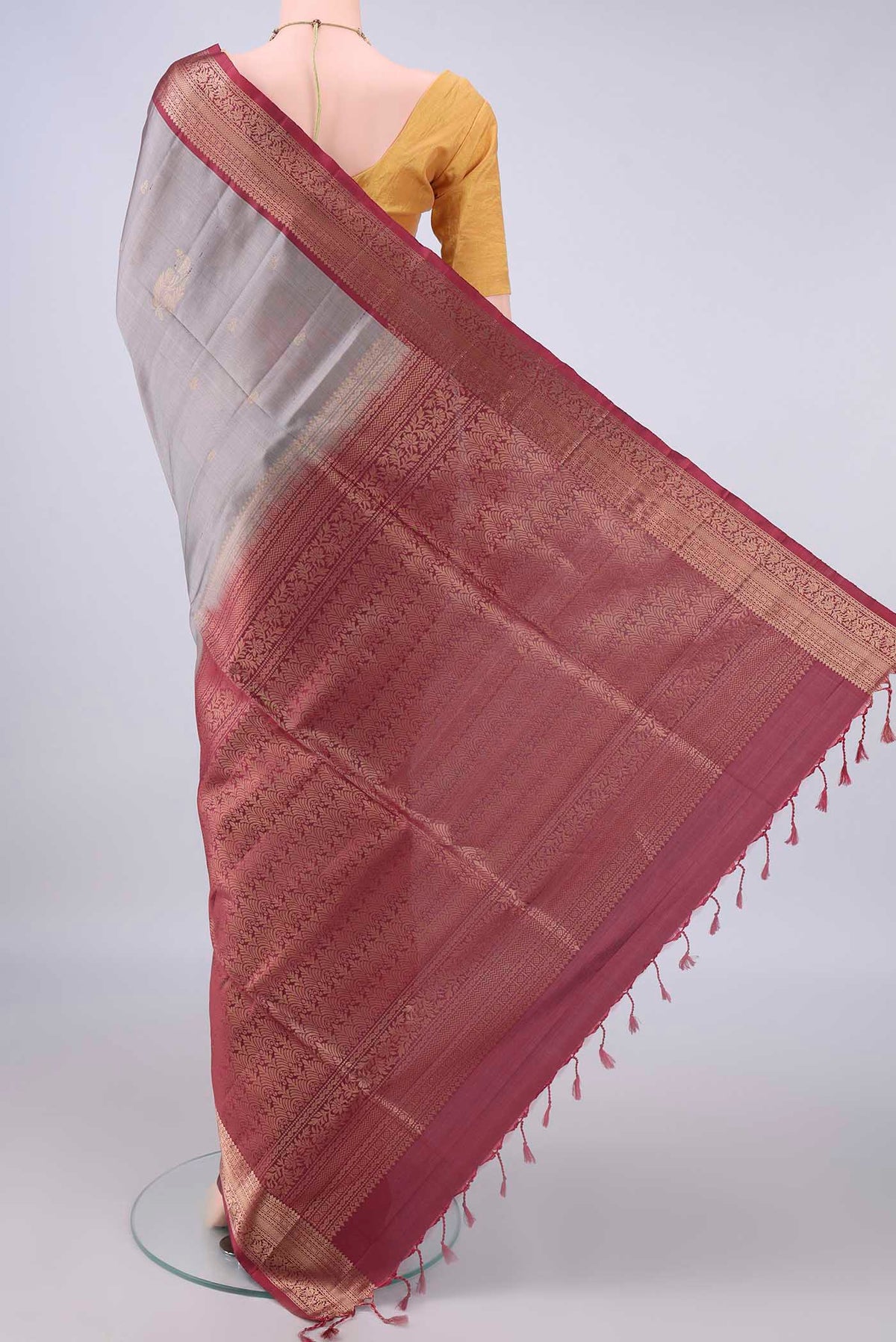 Flat view of Pure Silk Grey Soft Saree with Zari Butta on the body and Zari Border. 