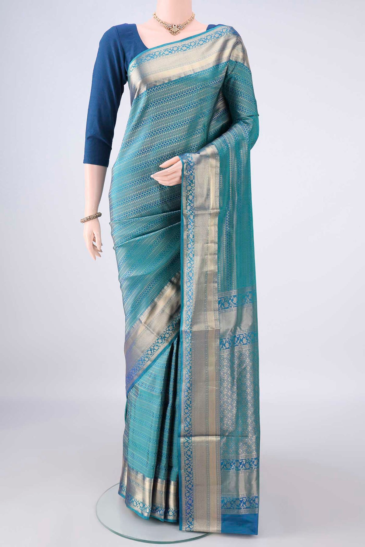 Pure Silk Peacock Blue Dual Tone Soft Saree with Zari Brocade on the body and Zari Border.  displayed on a mannequin