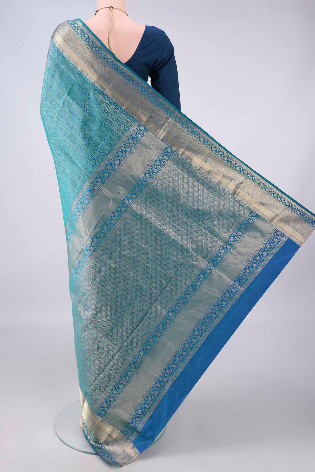 Flat view of Pure Silk Peacock Blue Dual Tone Soft Saree with Zari Brocade on the body and Zari Border. 