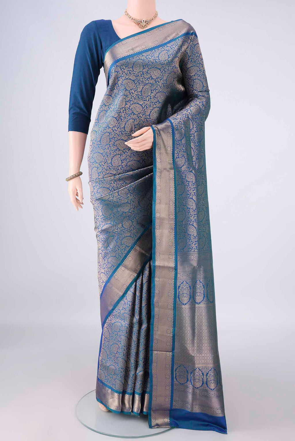 Pure Silk Peacock Blue Soft Saree with Zari Brocade on the body and Zari Border.  displayed on a mannequin