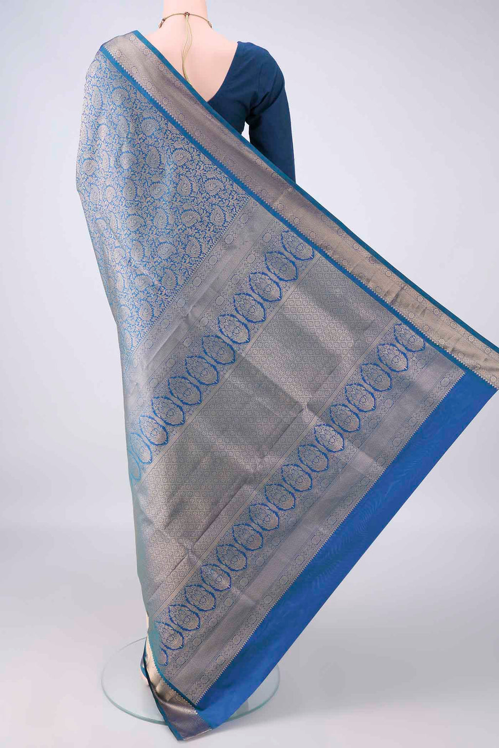 Flat view of Pure Silk Peacock Blue Soft Saree with Zari Brocade on the body and Zari Border. 