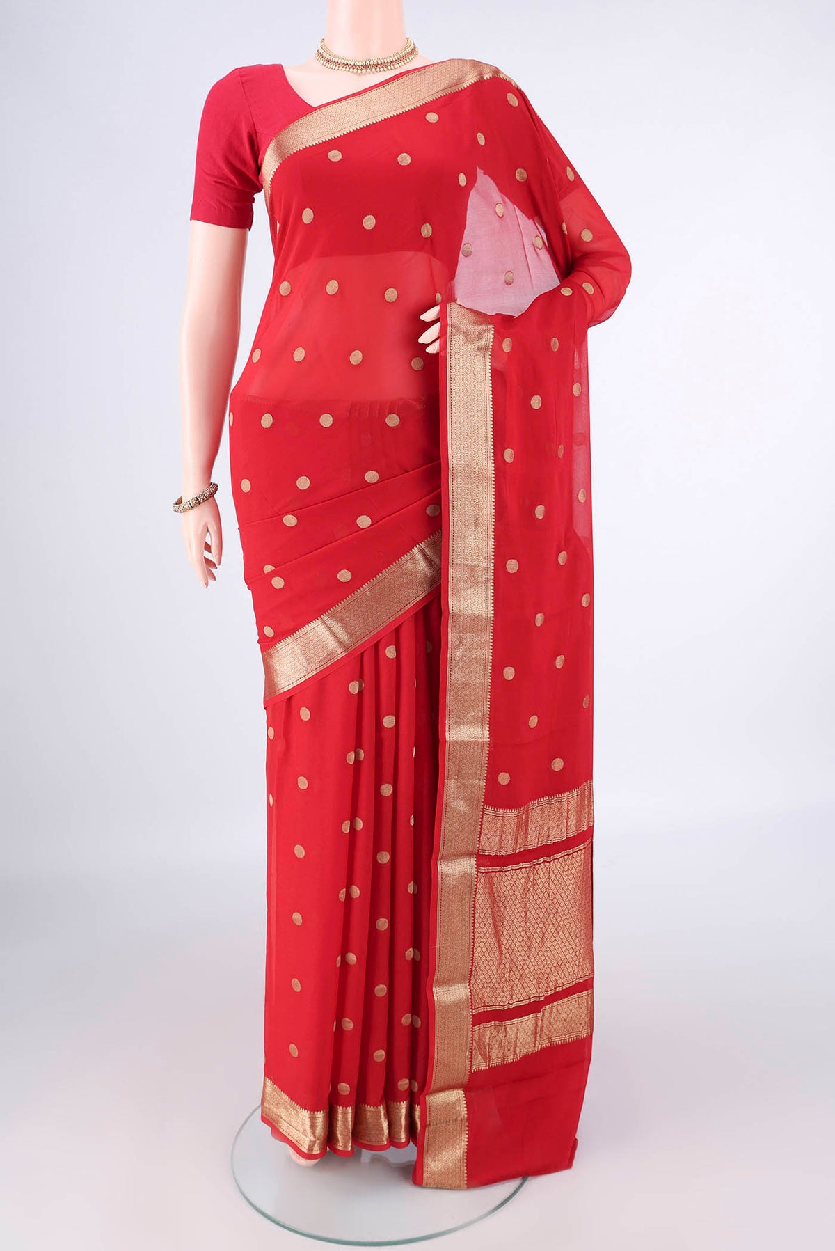 Red Mysore Georgette Saree with Zari Butta on the body and Zari Border.  displayed on a mannequin