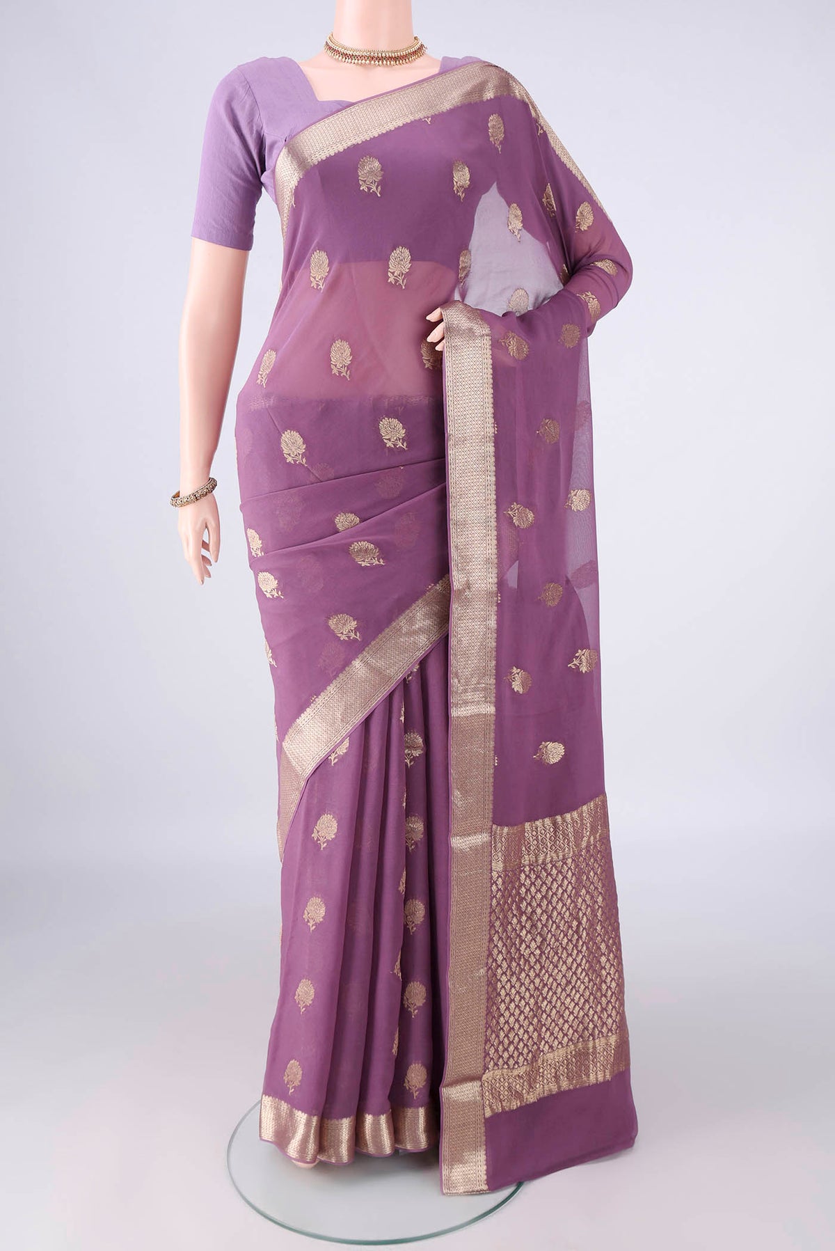 Lavender Mysore Georgette Saree with Zari Butta on the body and Zari Border.  displayed on a mannequin
