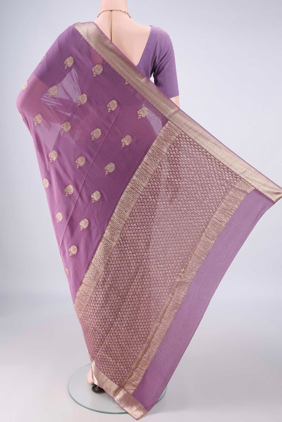 Flat view of Lavender Mysore Georgette Saree with Zari Butta on the body and Zari Border. 