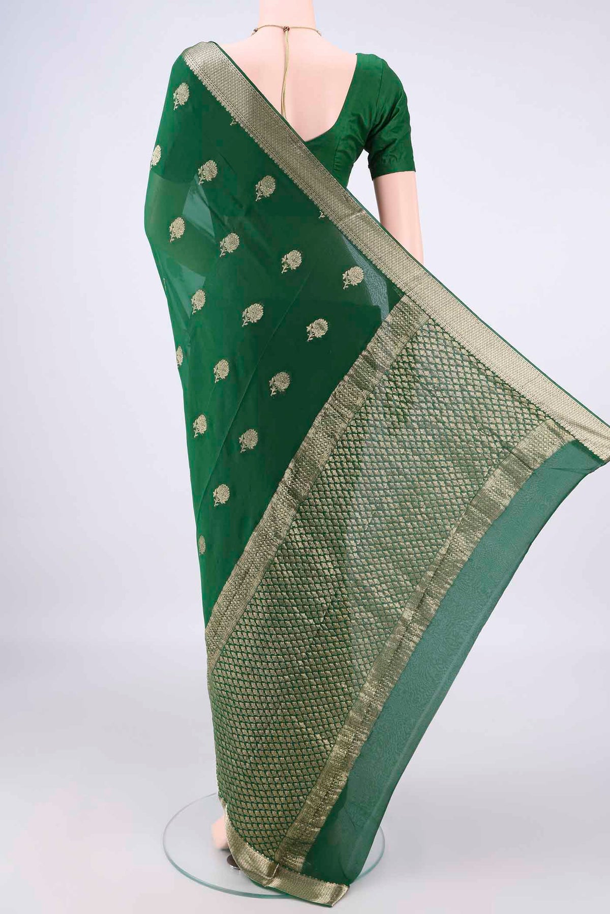 Flat view of Green Mysore Georgette Saree with Zari Butta on the body and Zari Border. 