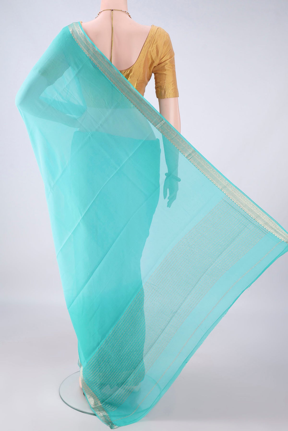 Flat view of Turquoise Mysore Georgette Saree with Plain Body and Zari Border. 
