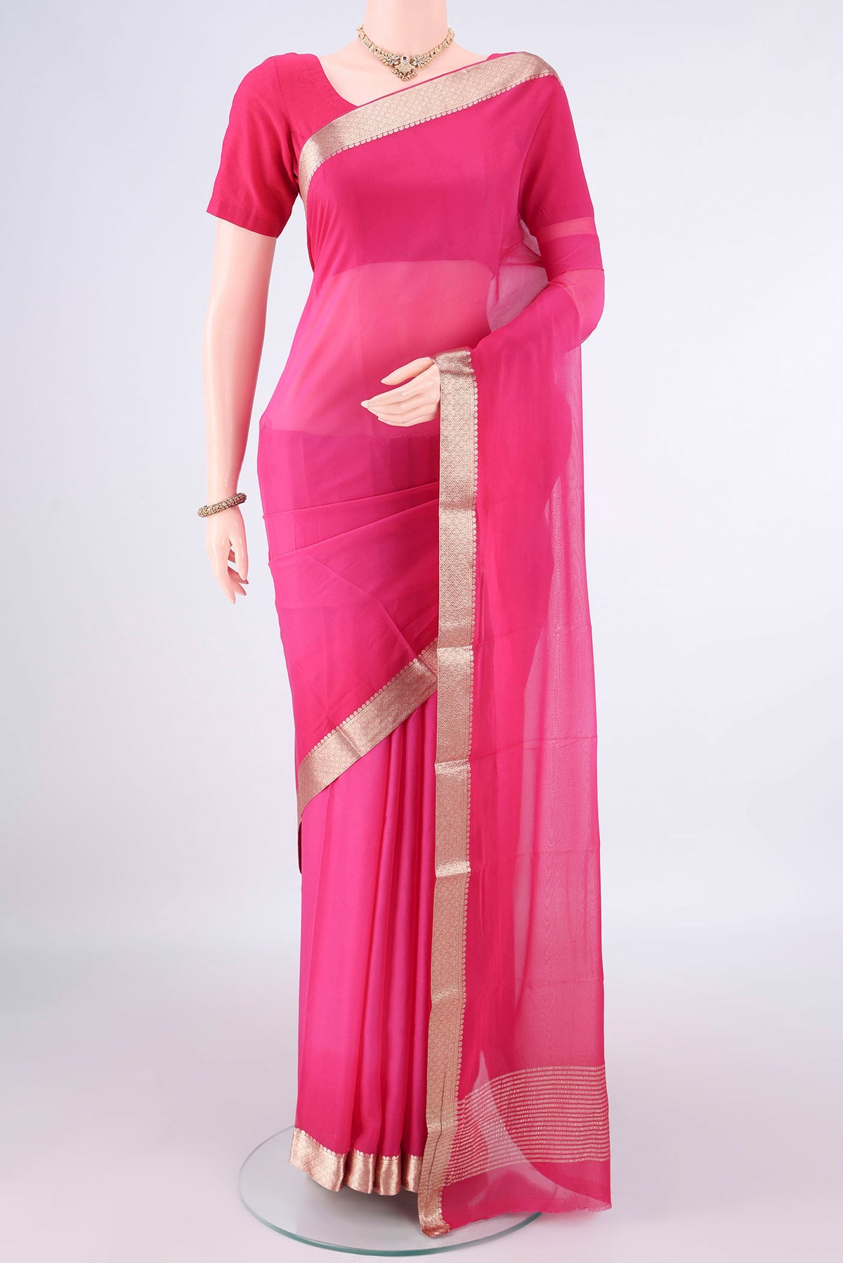 Rani Pink Mysore Georgette Saree with Plain Body and Zari Border.  displayed on a mannequin