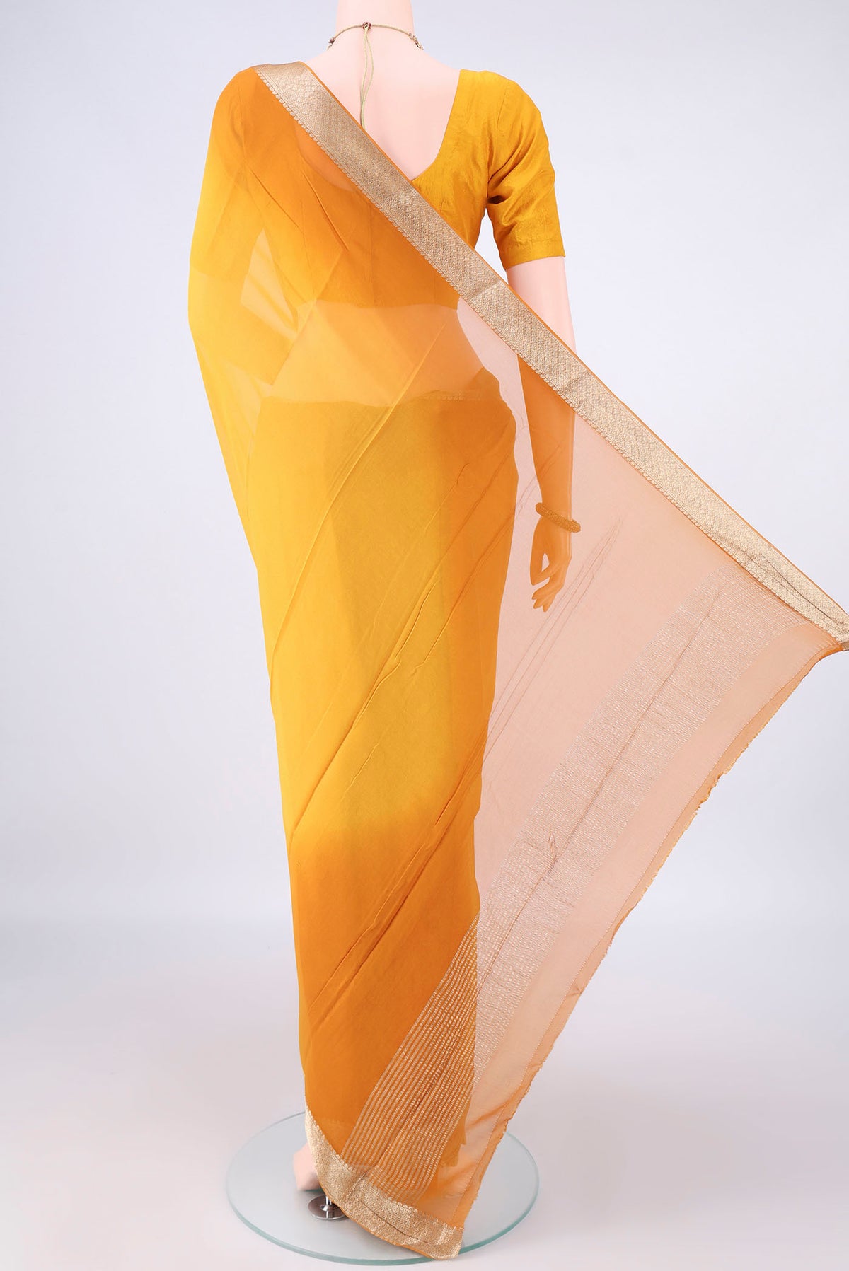 Flat view of Yellow Mysore Georgette Saree with Plain Body and Zari Border. 