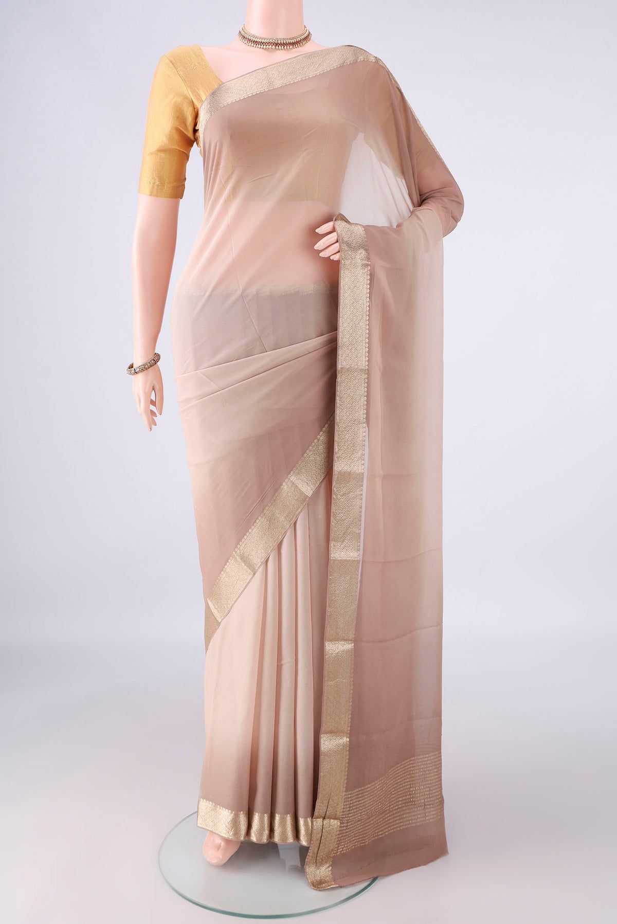 Dark Beige Mysore Georgette Saree with Plain Body and Zari Border.  displayed on a mannequin