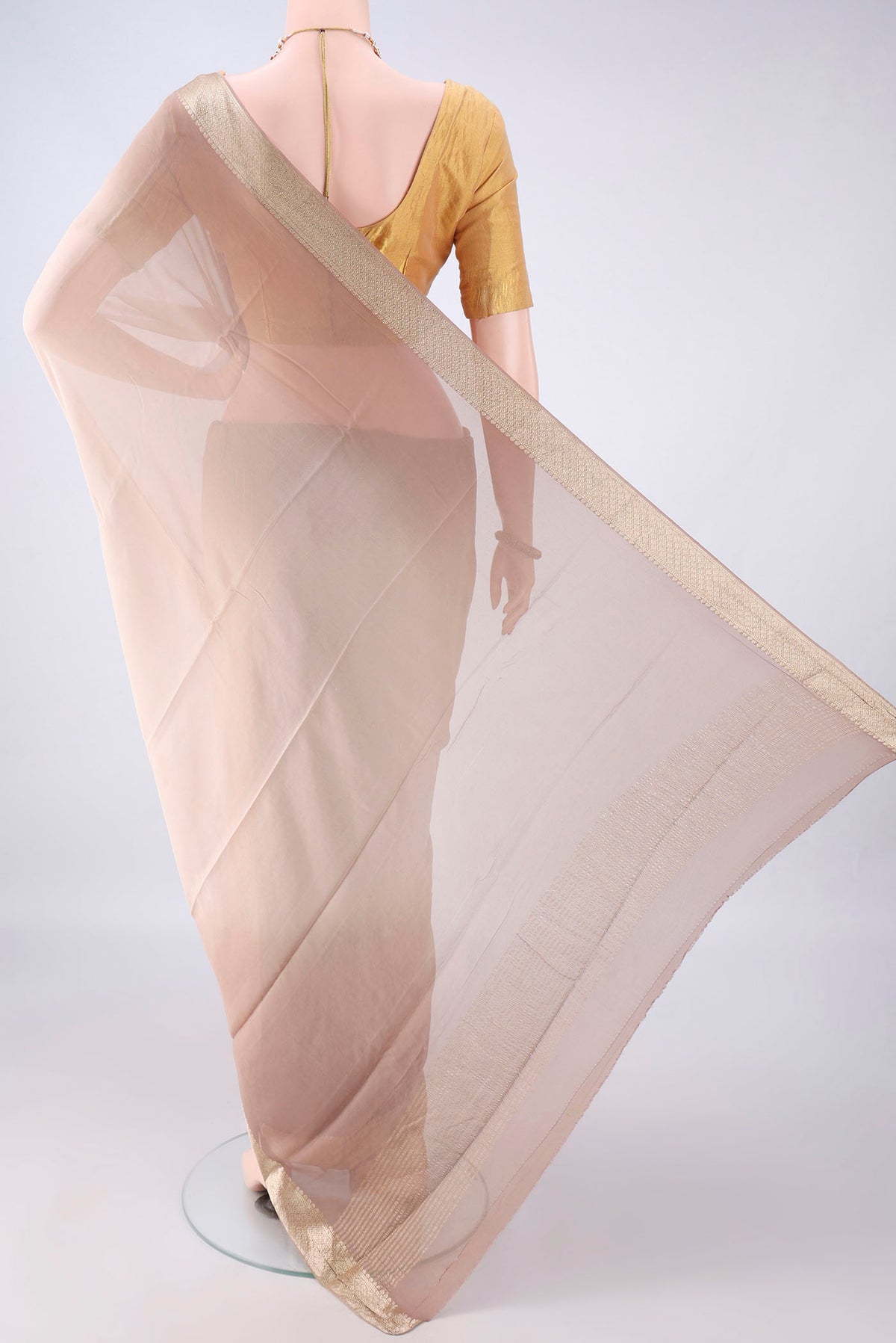Flat view of Dark Beige Mysore Georgette Saree with Plain Body and Zari Border. 