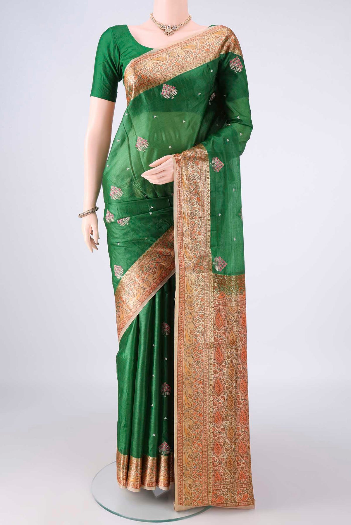 Bottle Green Banarasi Tussar Saree with Embroidered on the body and Zari Border.  displayed on a mannequin