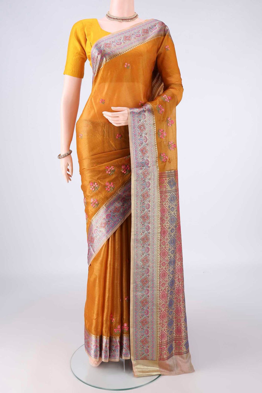 Mustard Banarasi Tussar Saree with Embroidered on the body and Zari Border.  displayed on a mannequin
