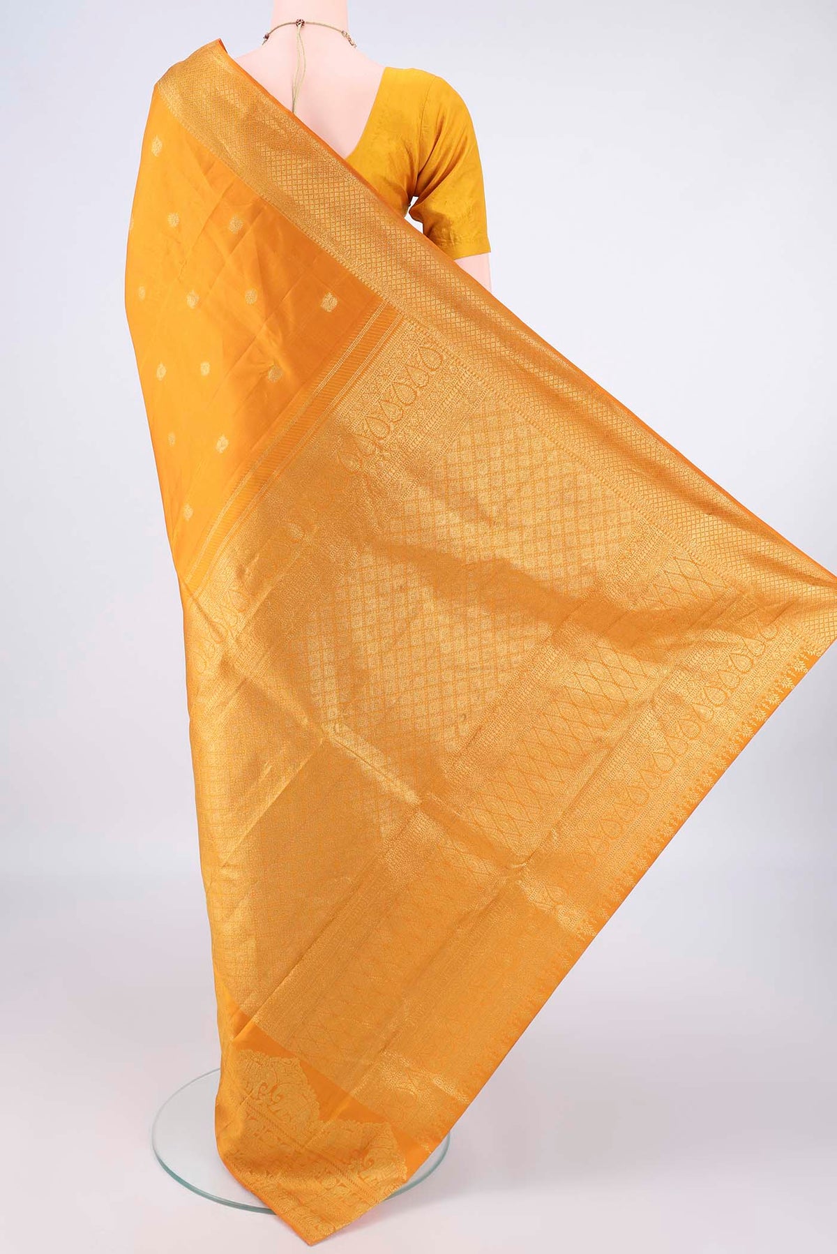 Flat view of Pure Silk Mustard Kanchipuram Saree with Zari Butta on the body and Zari Border. 
