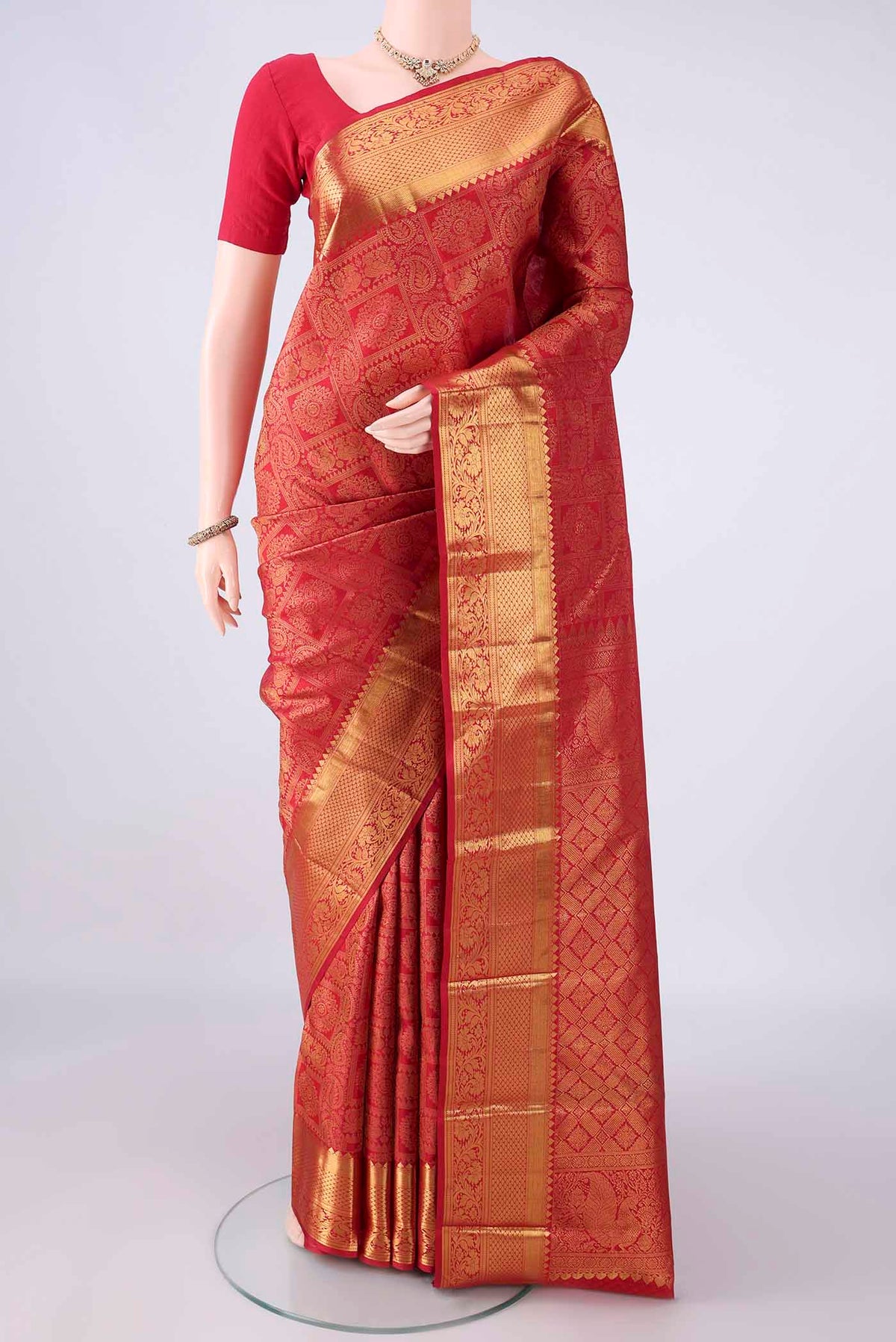 Pure Silk Red Kanjivaram Saree with Zari Brocade on the body and Zari Border.  displayed on a mannequin