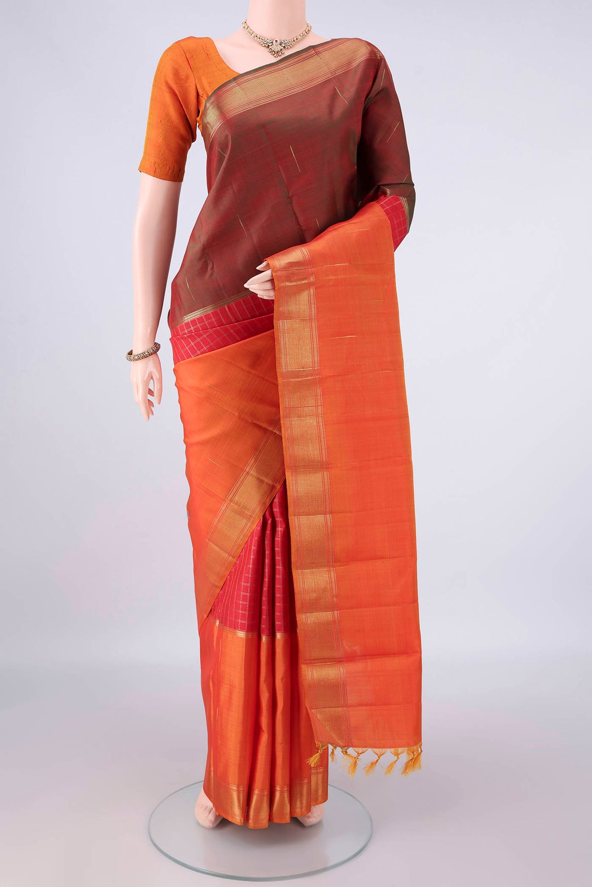 Pure Silk Pure Zari Red Kanjivaram Saree with Checked design on the body and Ganga Jamuna Border.  displayed on a mannequin