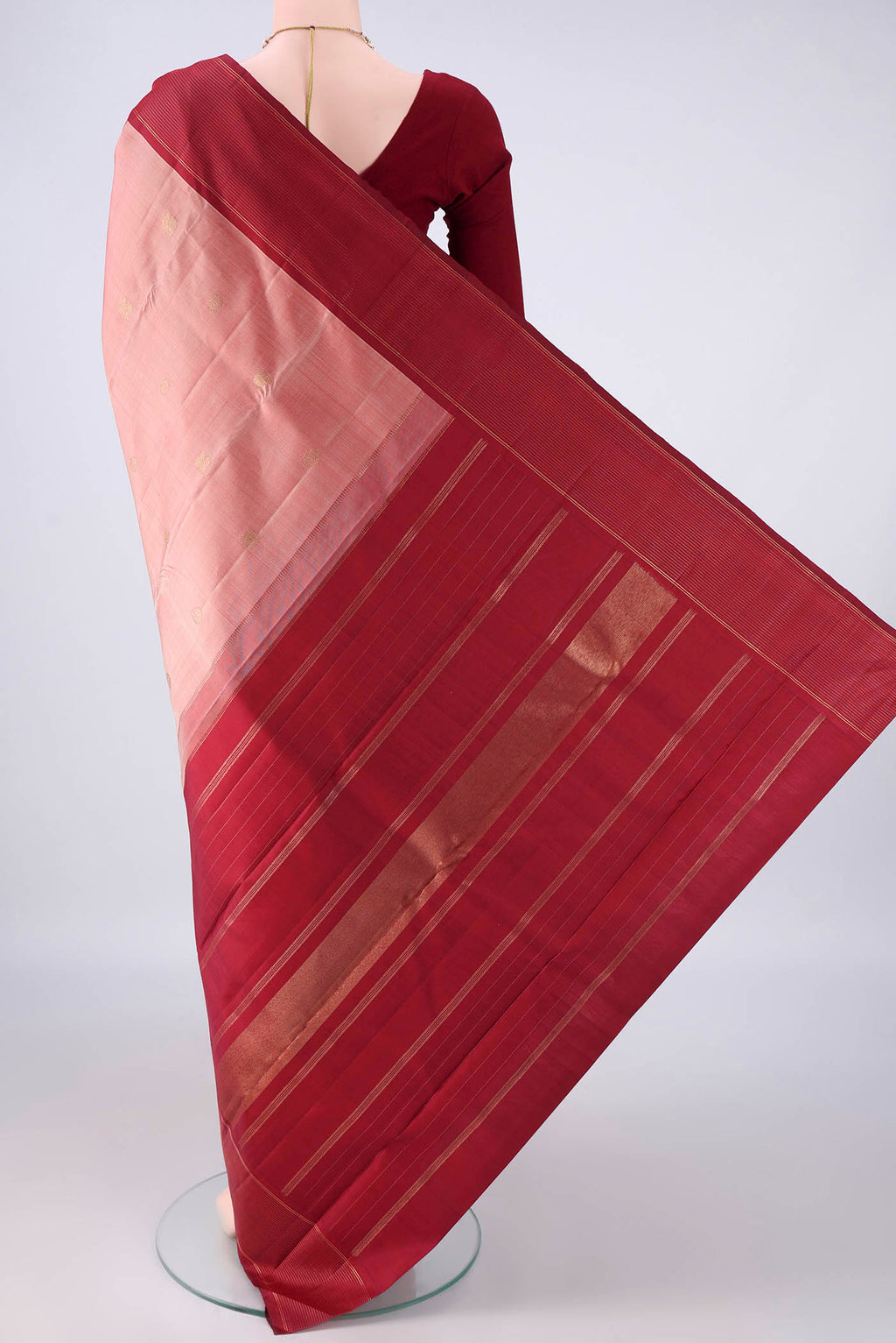 Flat view of Pure Silk Pure Zari Peach Kanchipuram Saree with Zari Butta on the body and Plain Border. 
