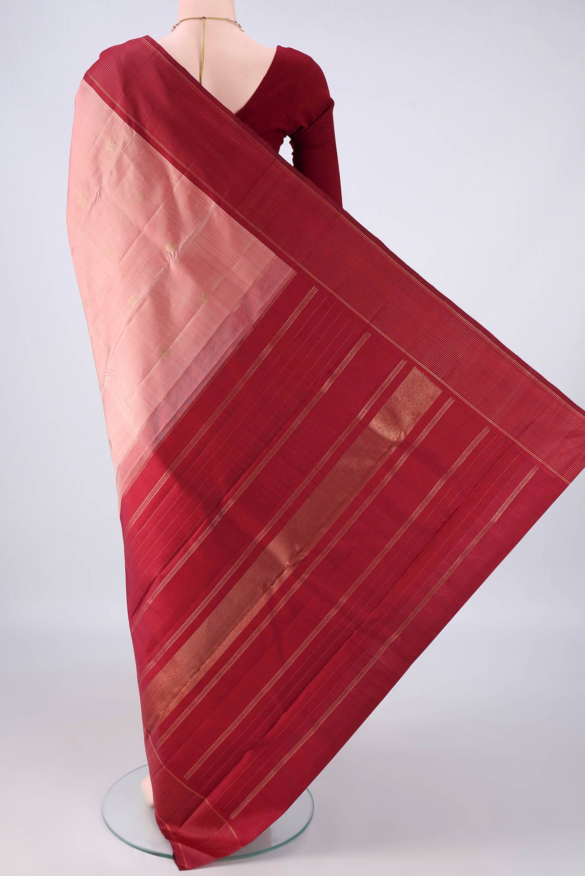 Flat view of Pure Silk Pure Zari Peach Kanchipuram Saree with Zari Butta on the body and Plain Border. 