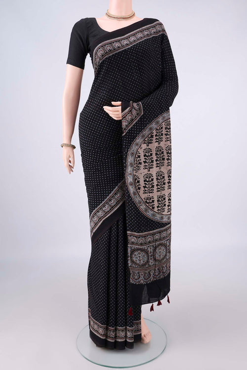 Black Cotton Saree with Ajrakh Print on the body and Plain Border.  displayed on a mannequin