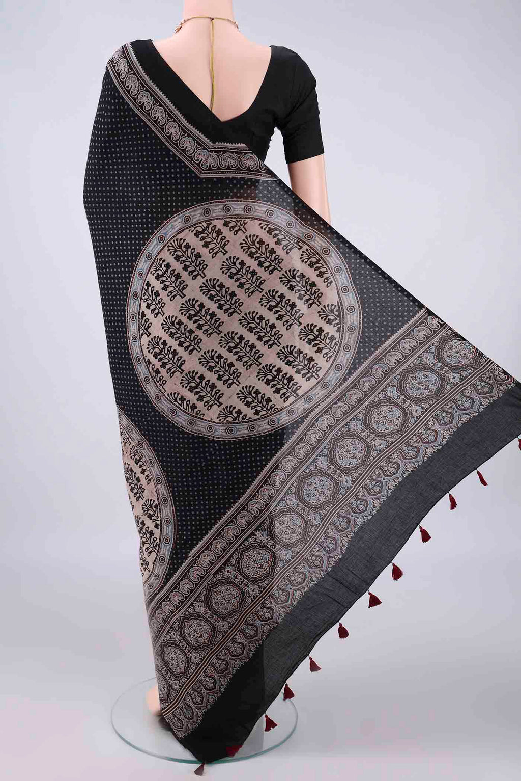 Flat view of Black Cotton Saree with Ajrakh Print on the body and Plain Border. 