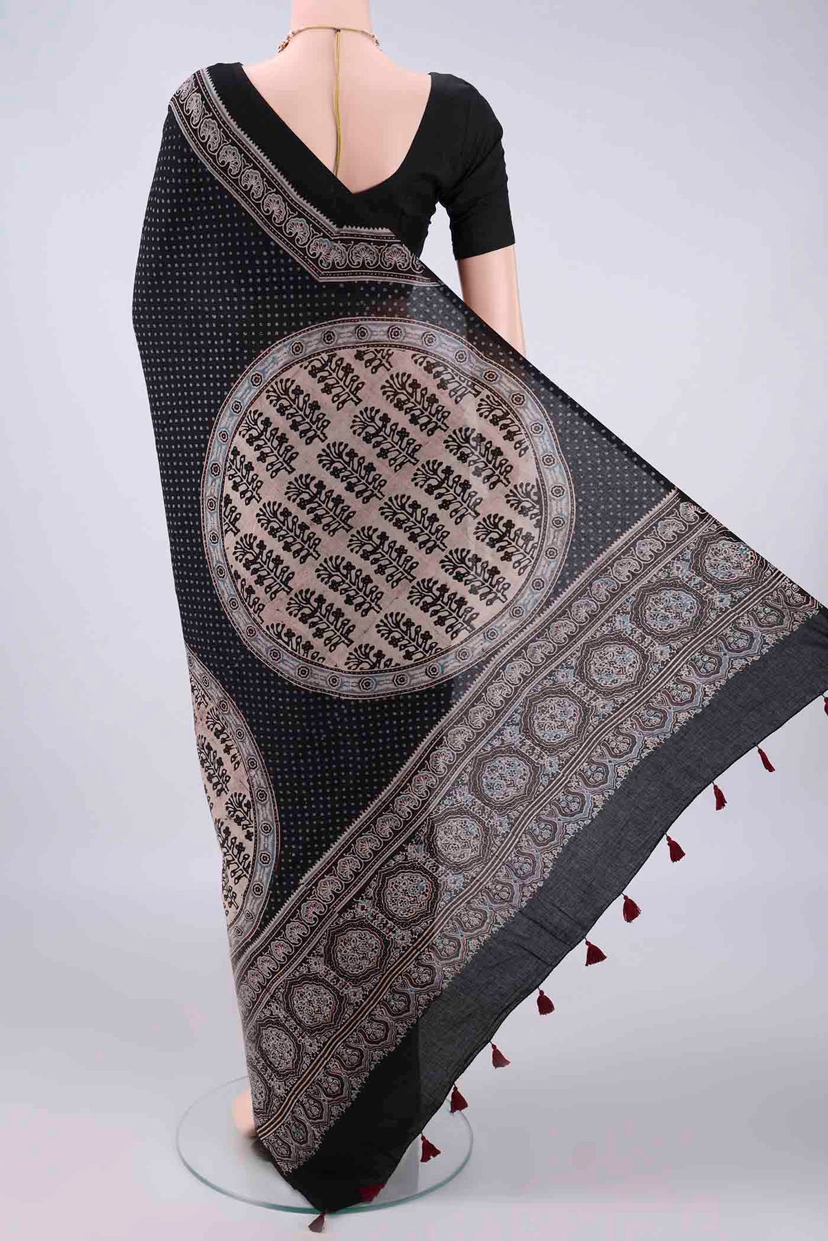 Flat view of Black Cotton Saree with Ajrakh Print on the body and Plain Border. 