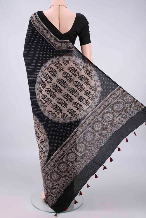 Flat view of Black Cotton Saree with Ajrakh Print on the body and Plain Border. 