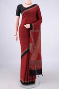 Rust Cotton Saree with Ajrakh Print on the body and Plain Border.  displayed on a mannequin