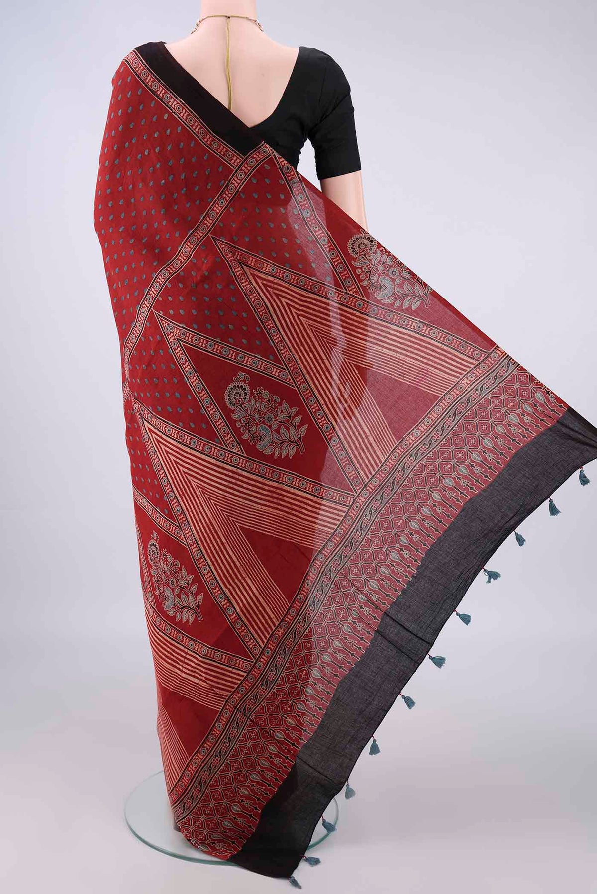 Flat view of Rust Cotton Saree with Ajrakh Print on the body and Plain Border. 