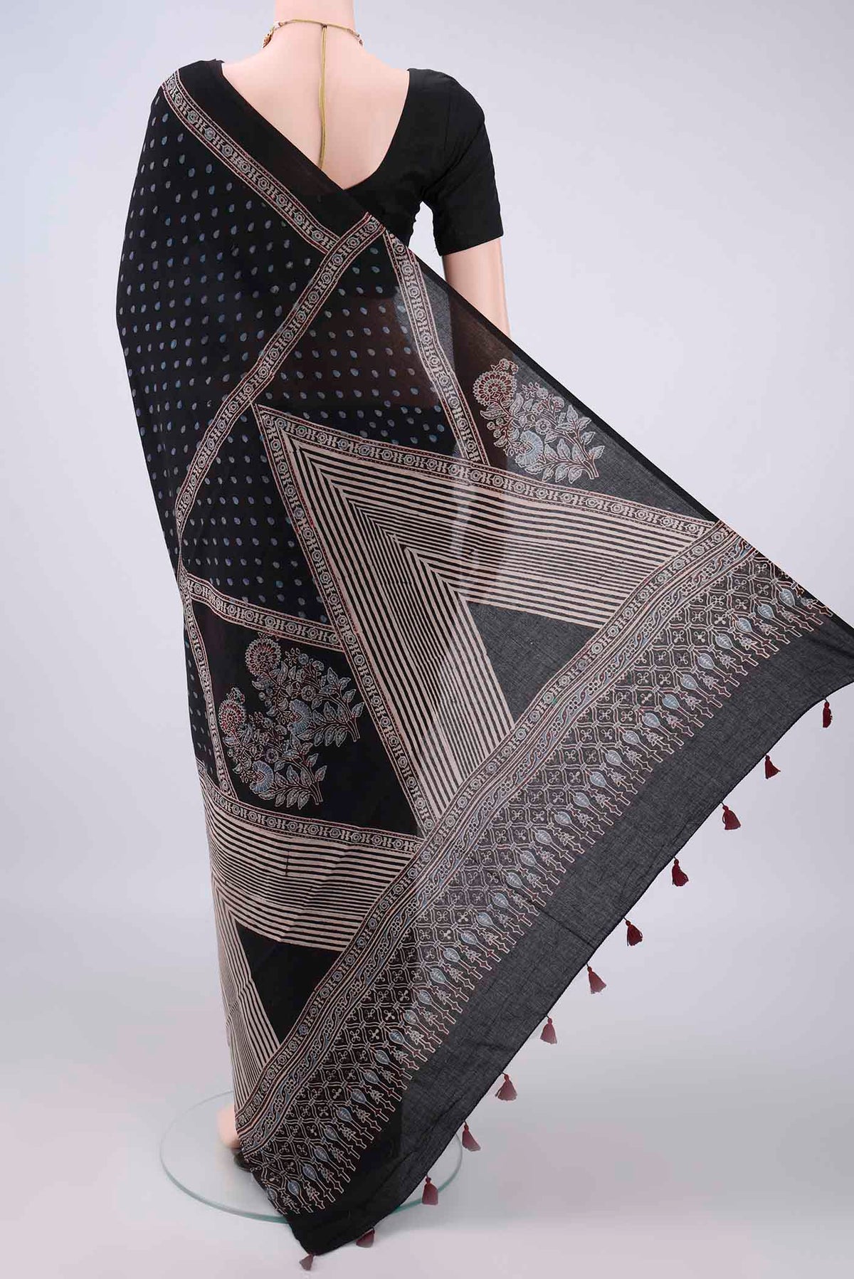 Flat view of Black Cotton Saree with Ajrakh Print on the body and Plain Border. 