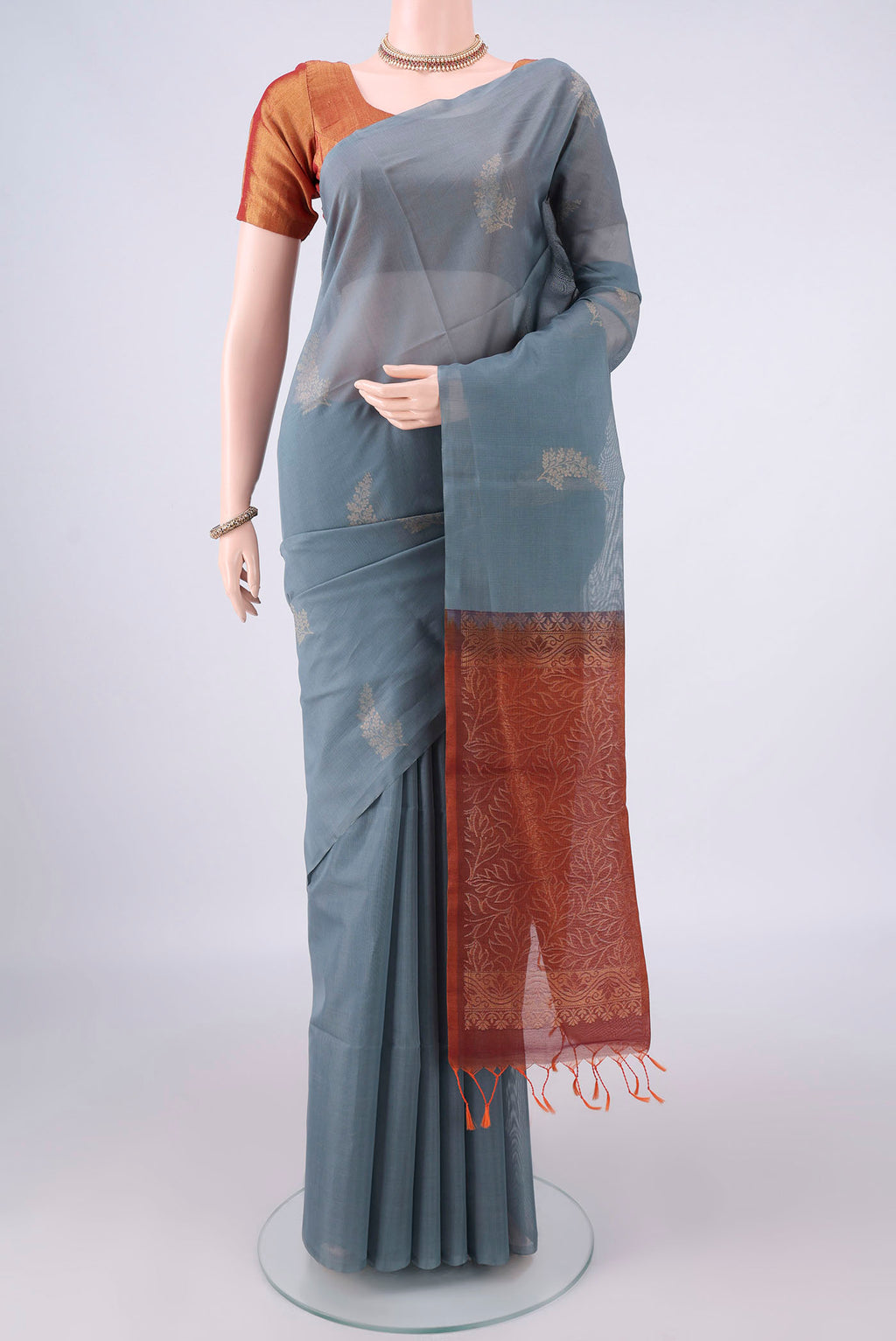 Grey Silk Cotton Saree with Zari Butta on the body and Without Border.  displayed on a mannequin
